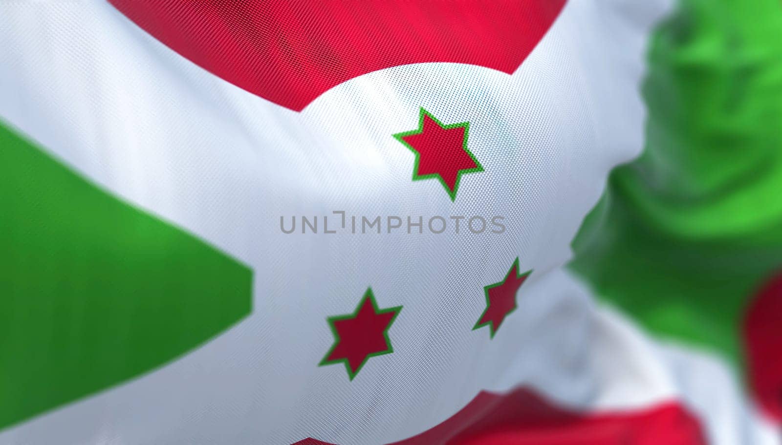 Close-up view of the Burundi national flag waving in the wind. The Republic of Burundi is a country located in the east Africa. Fabric textured background. Selective focus