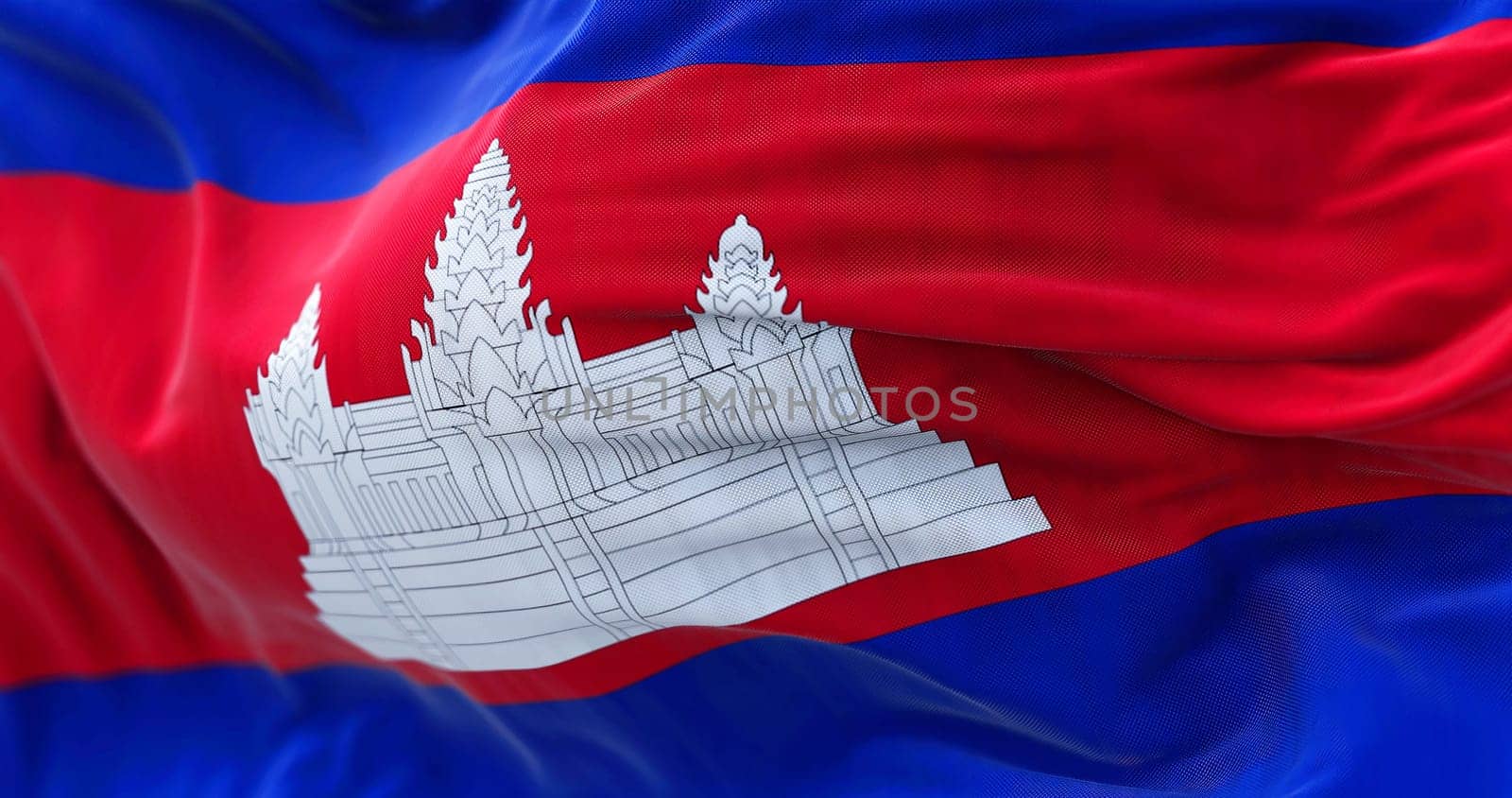 Close-up view of the Cambodia national flag waving in the wind. The Kingdom of Cambodia is a country in the Southeast Asia. Fabric textured background. Selective focus