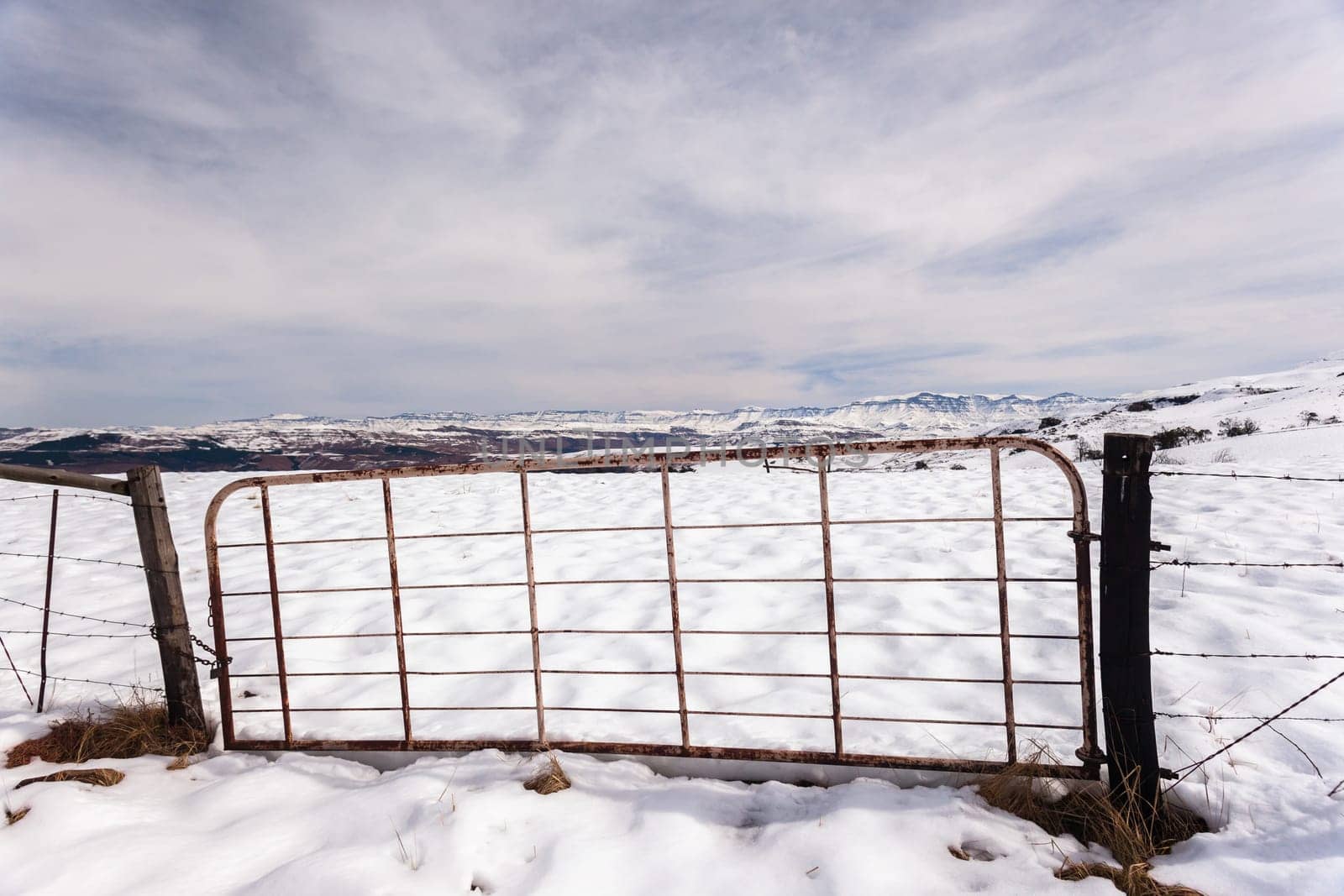Gate fence in  high plateau mountain terrain in winter snow scenic landscape
