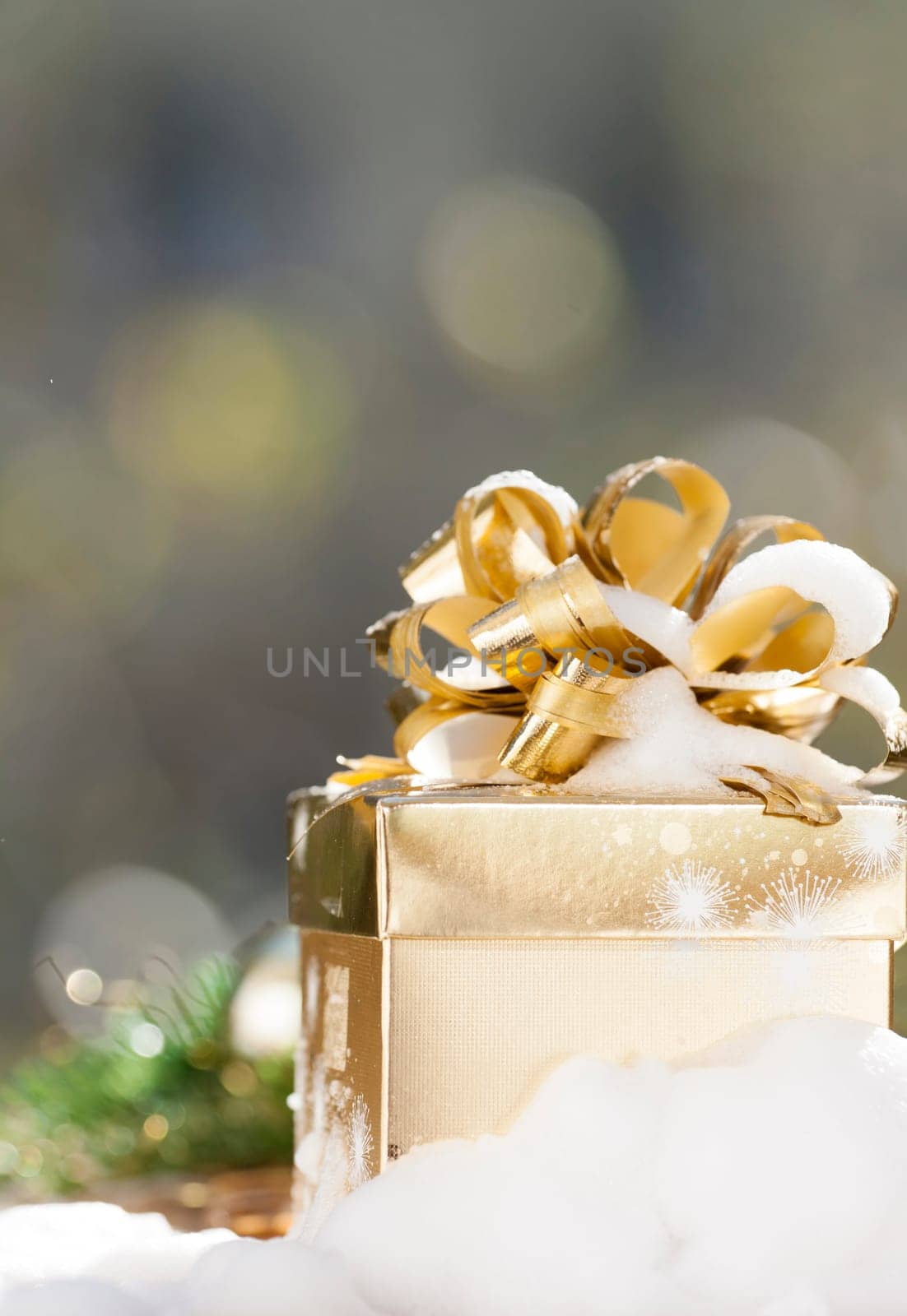 Golden Christmas background with present box on snow