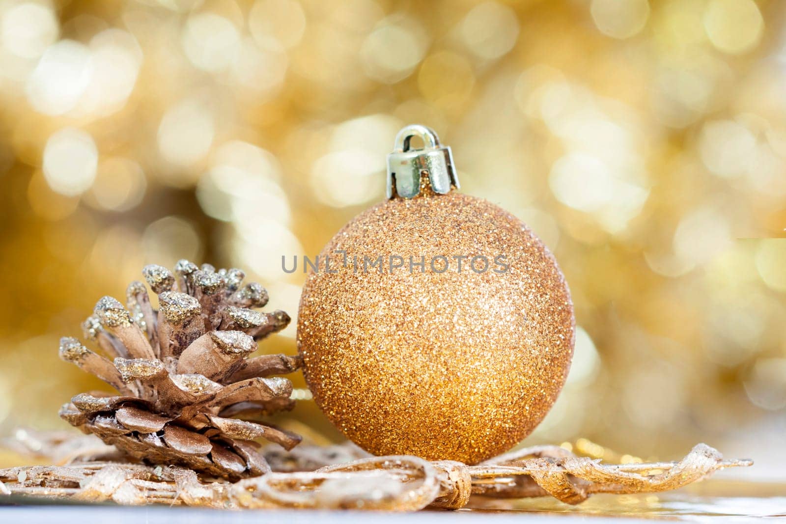 Golden Christmas background with christmas ball and cone
