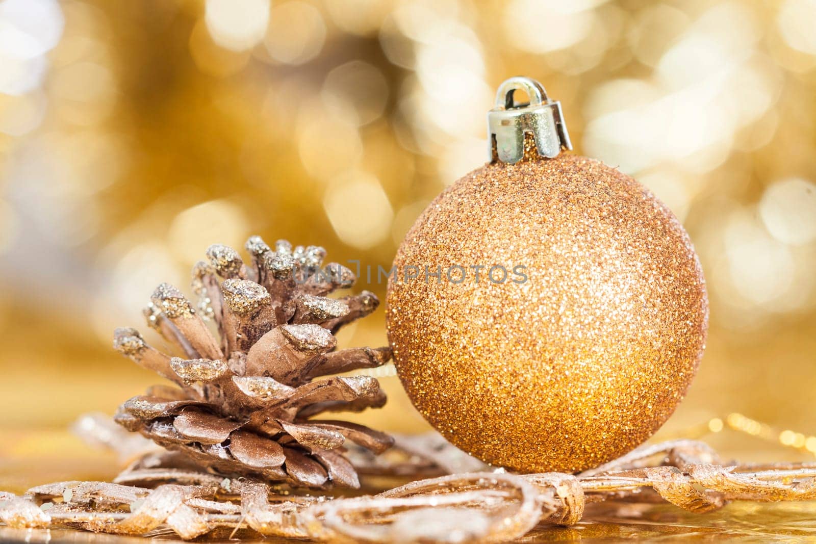 Golden Christmas background with christmas ball and cone