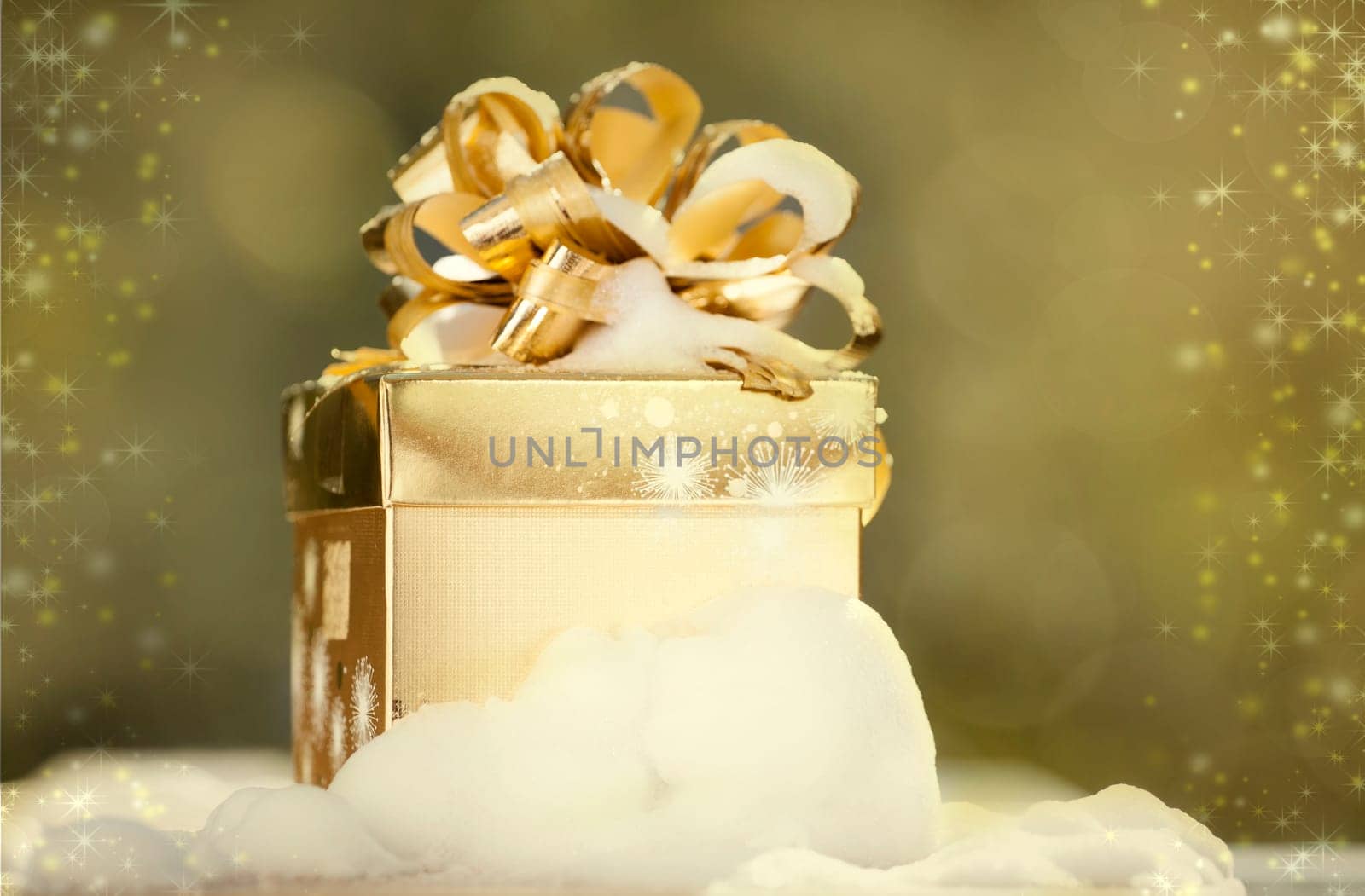 Golden Christmas background with present box on snow