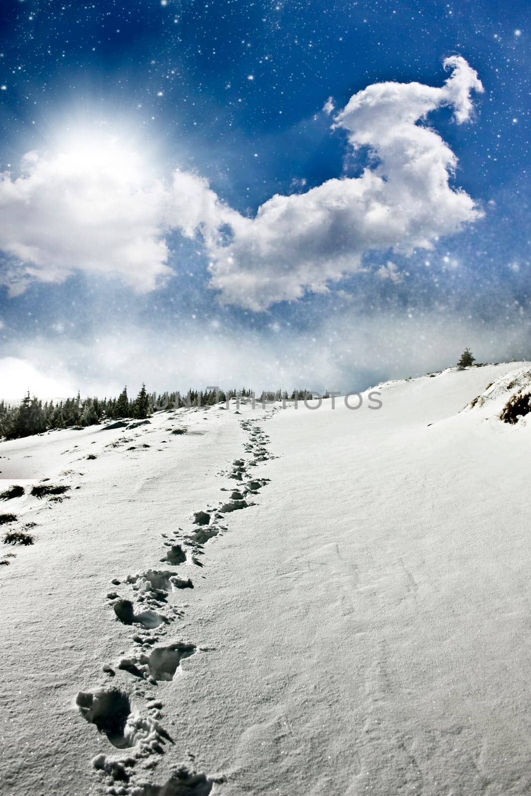Snowy path on the hillside and beautiful abtract evening sky