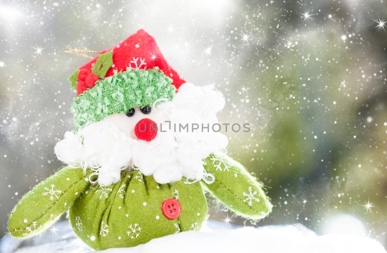 Christmas decoration with closeup on green Santa Claus figurine in the snow