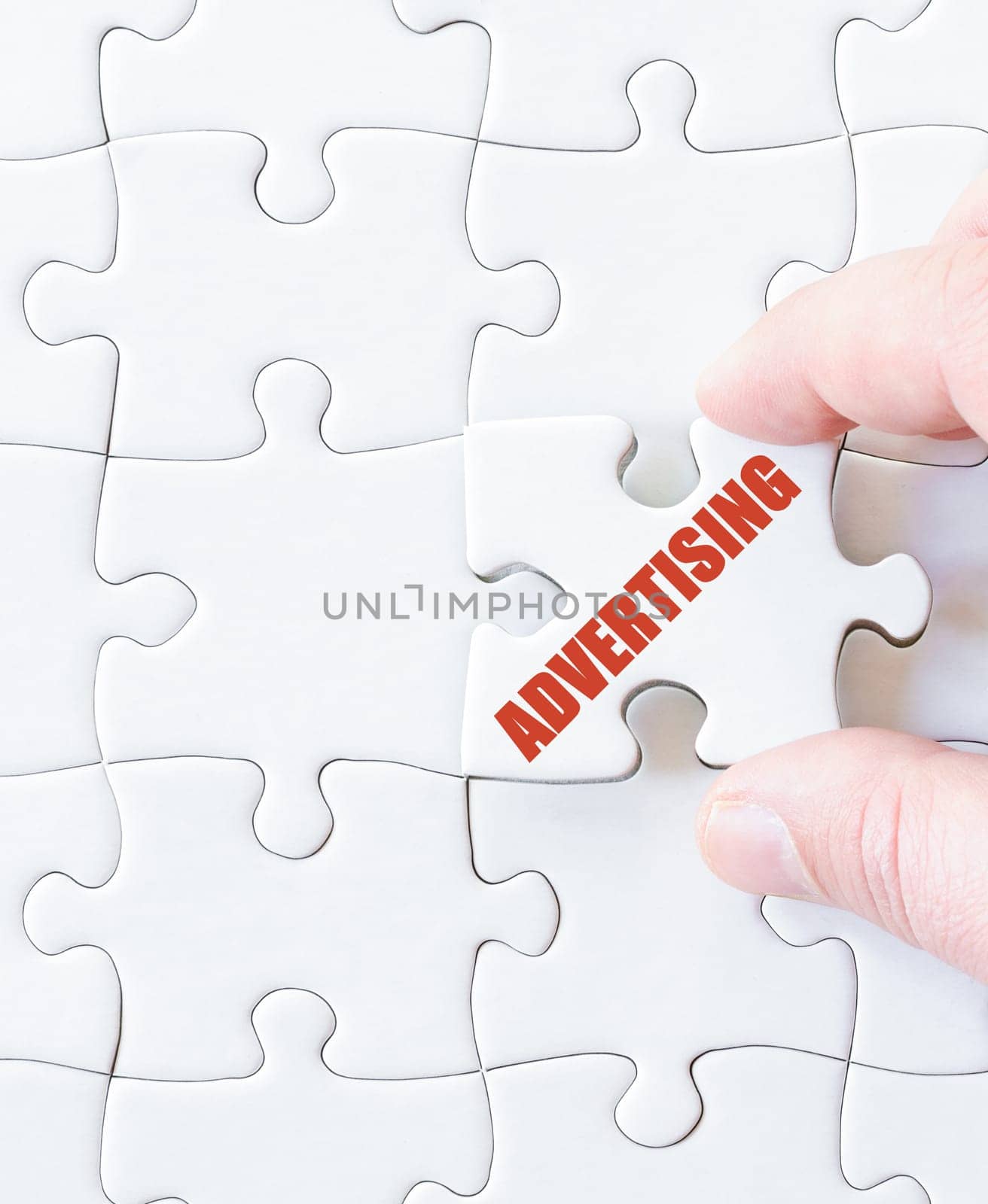 Missing jigsaw puzzle piece with word ADVERTISING. Business concept image for completing the puzzle.
