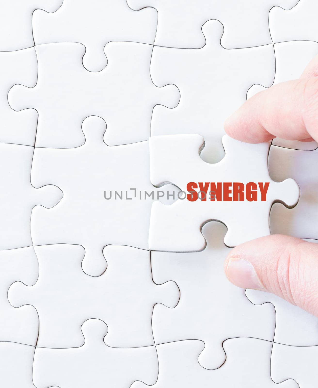 Missing jigsaw puzzle piece with word SYNERGY. Business concept image for completing the puzzle.