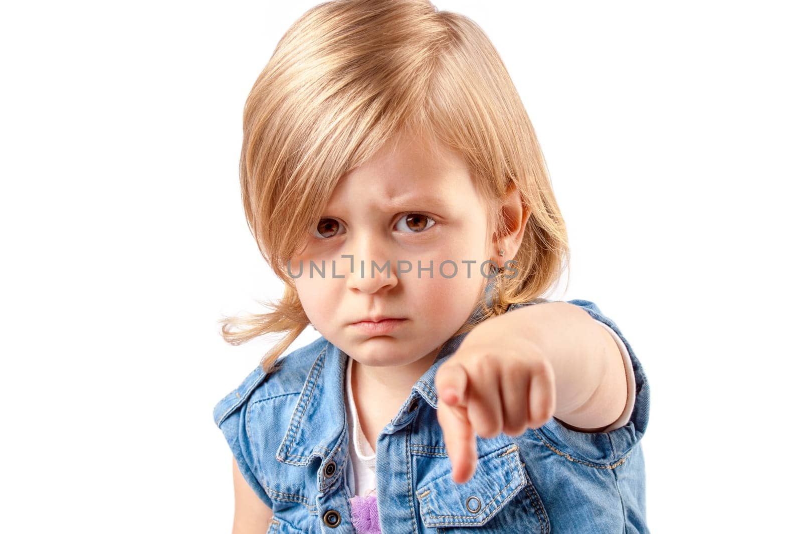 Portrait of a young angry girl pointing up