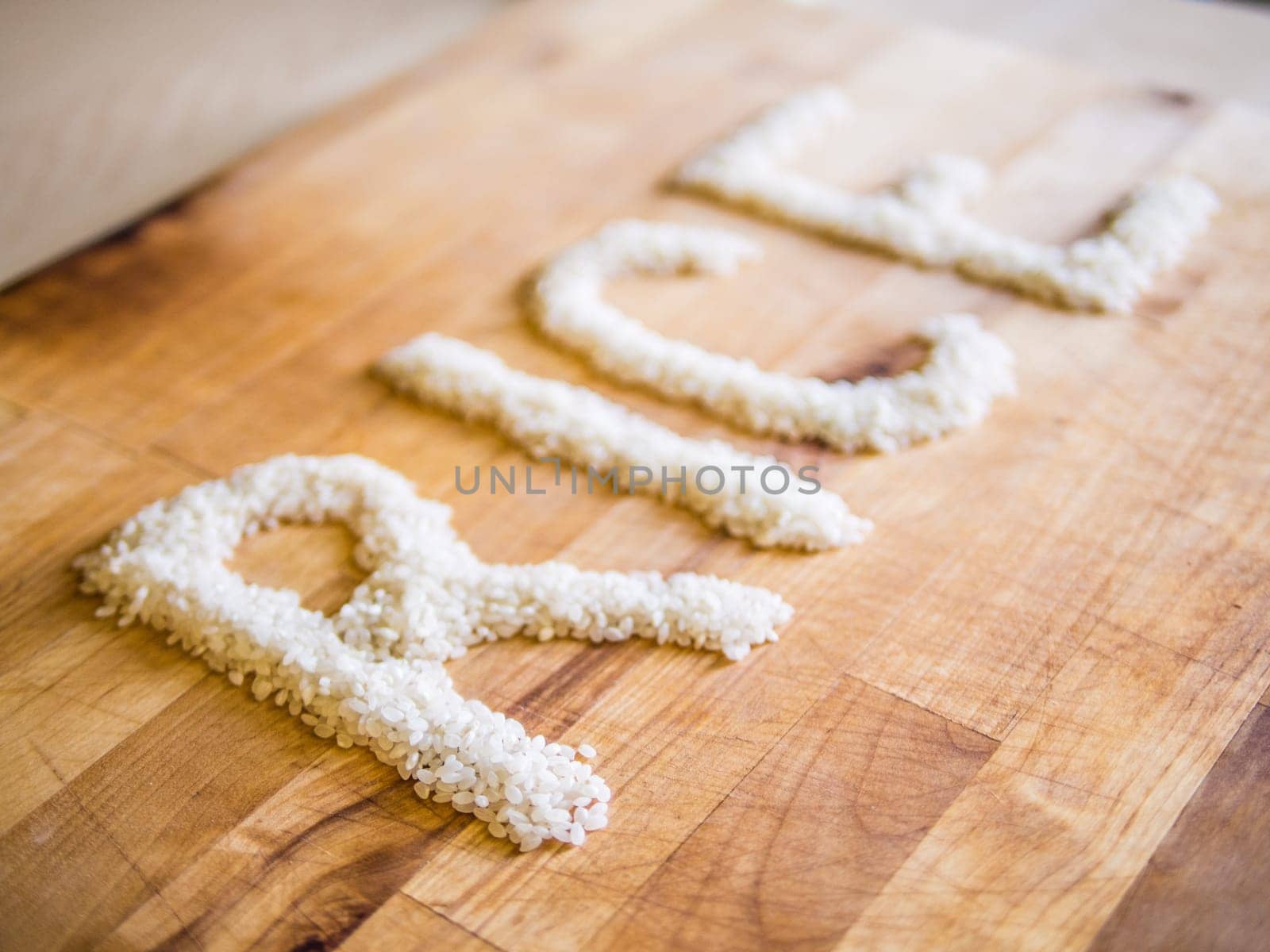 Rice word made of rice on wooden board