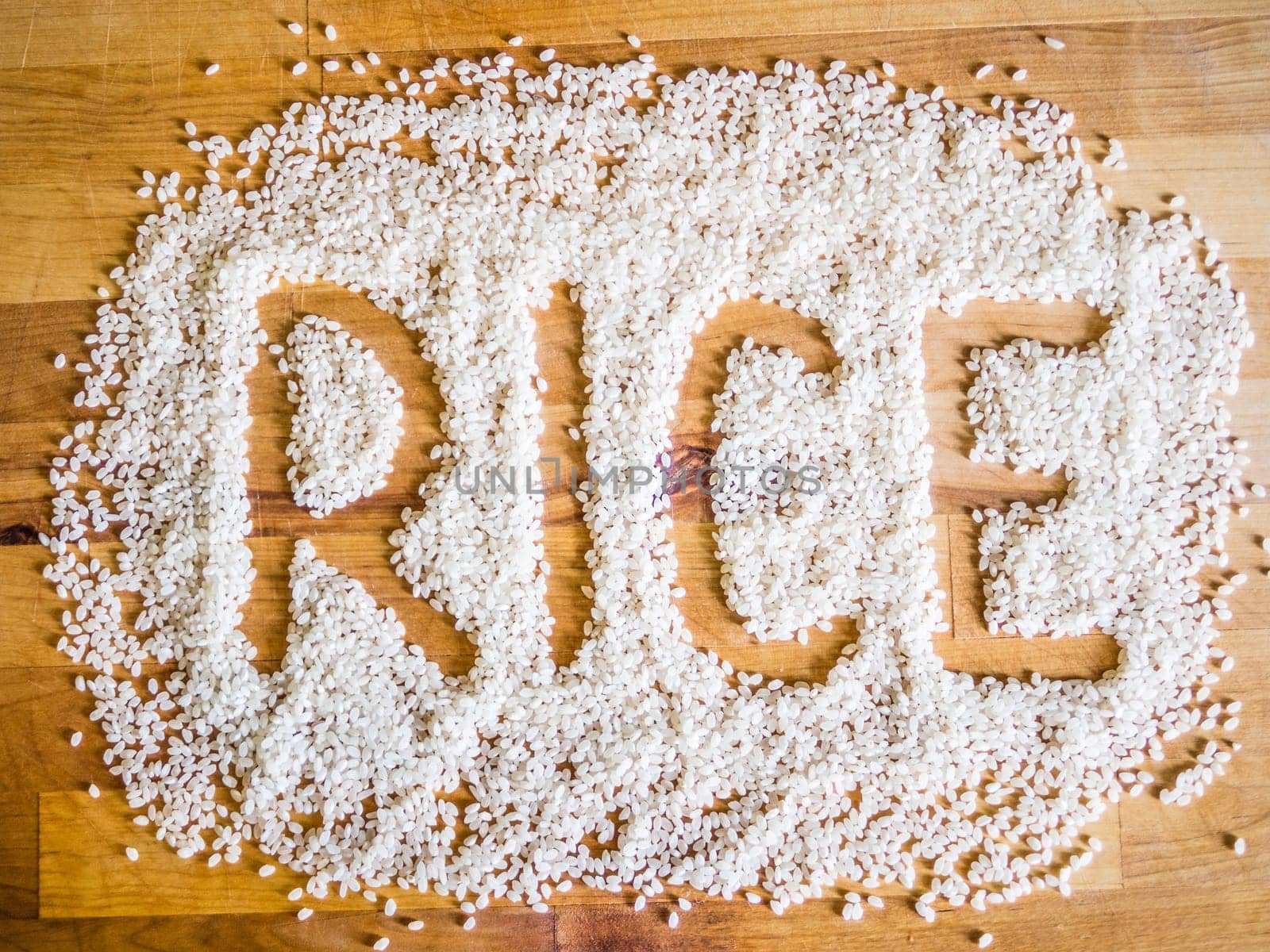 Rice word made of rice on wooden board