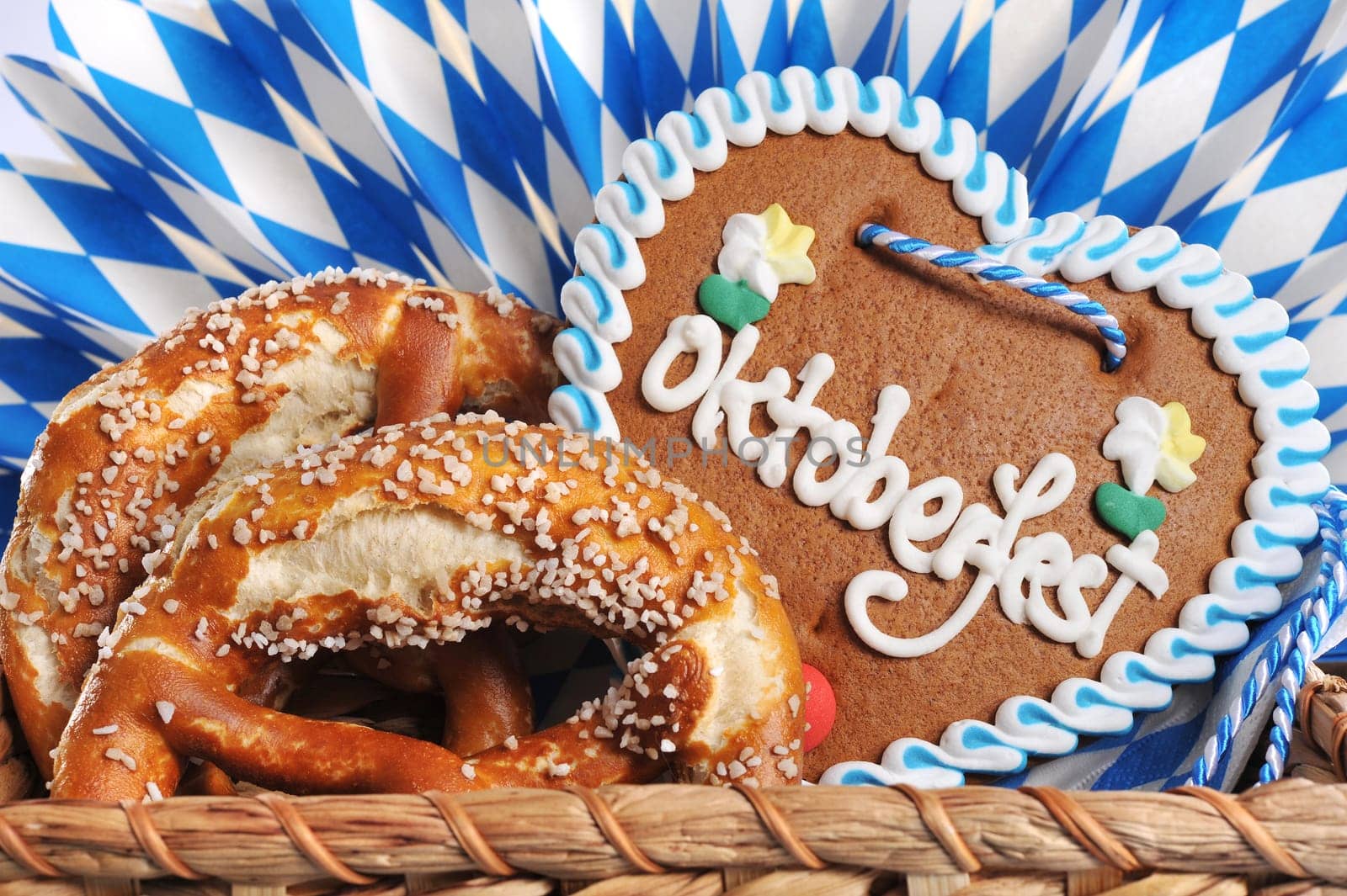 original Bavarian lye pretzels with Oktoberfest gingerbread heart in front of a wooden wall