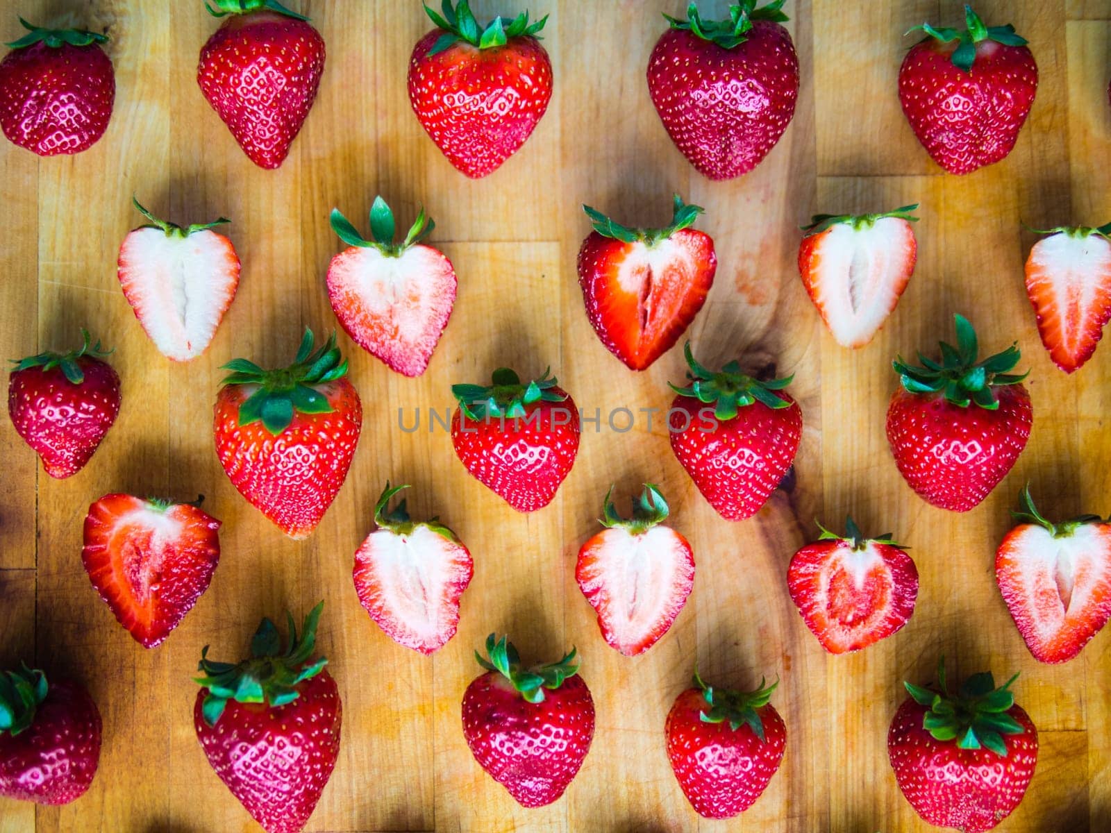 Arranged fresh strawberries on a wooden board