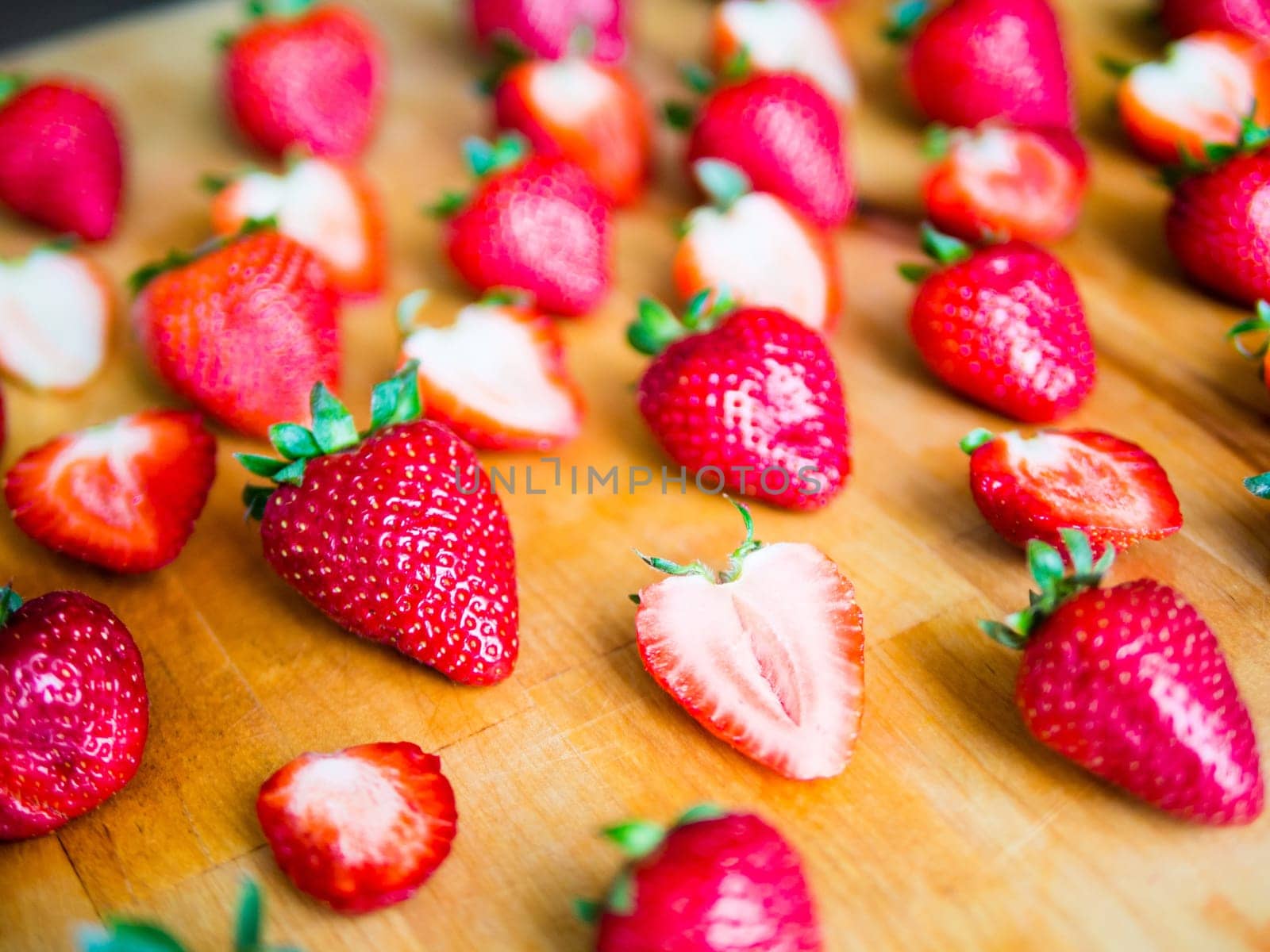 Arranged fresh strawberries on a wooden board