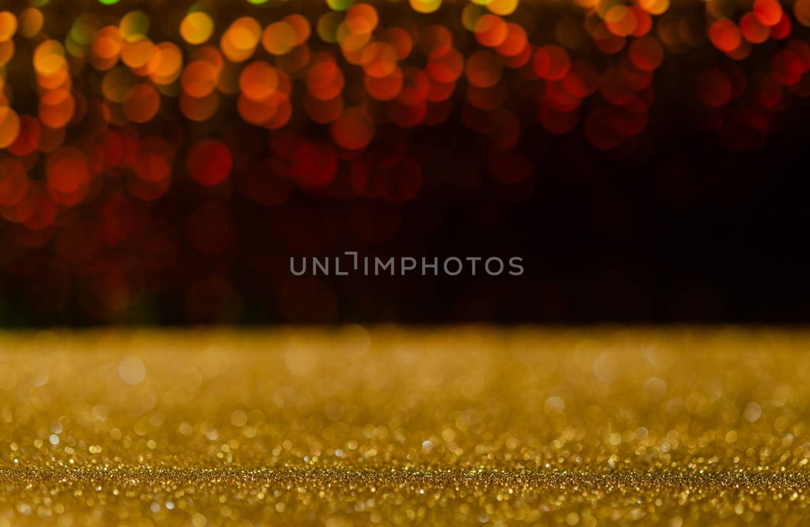 Golden glitter lights with abstract red bokeh on black background