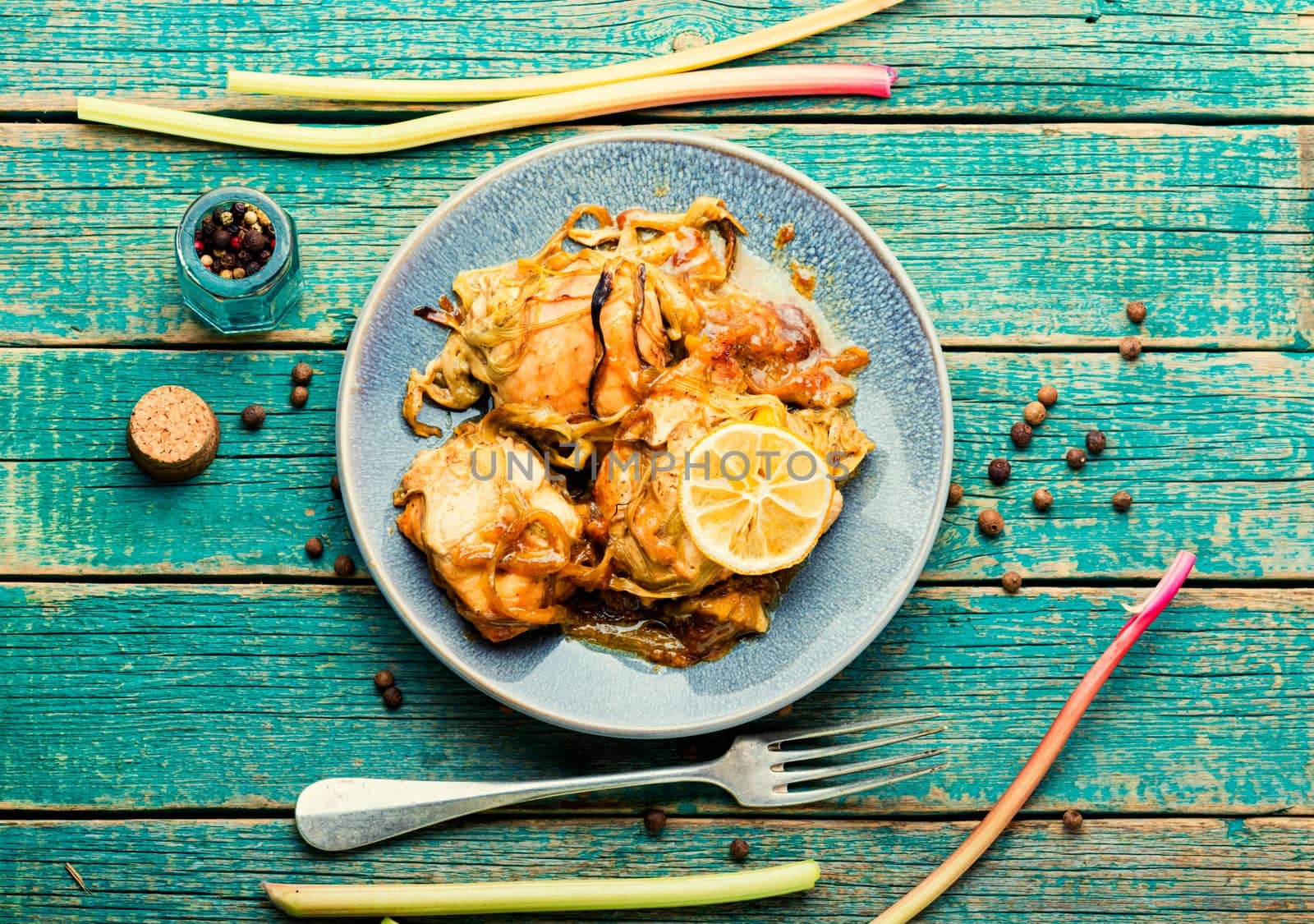 Delicious baked chicken meat with rhubarb stalks. Chicken breast with rhubarb sauce.