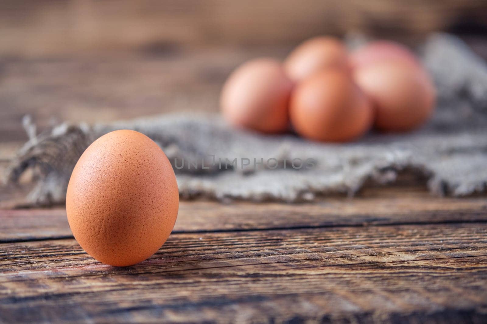 Close up view of brown chicken eggs on wooden table (photo with shallow depth of field)
