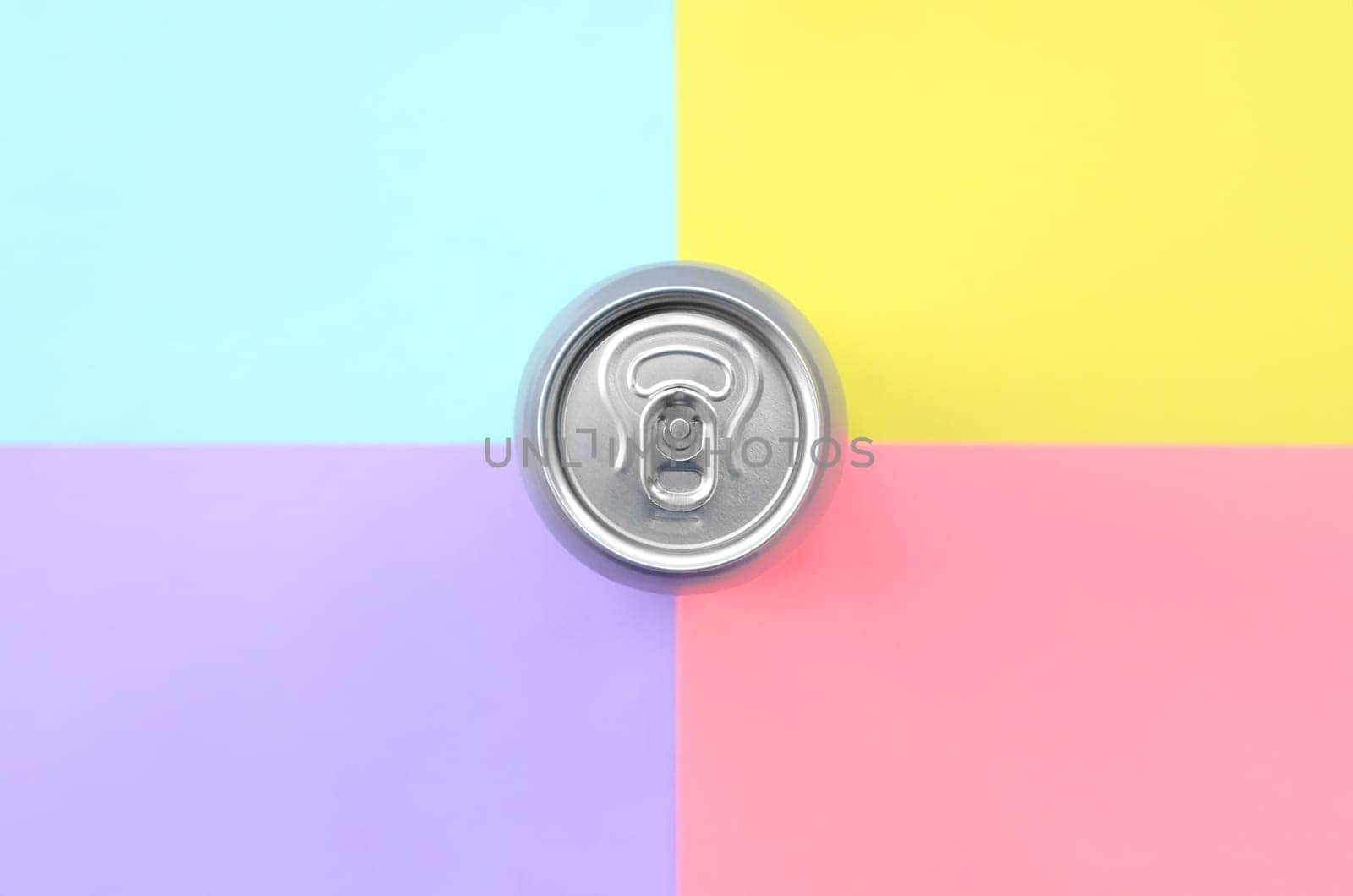 Tin aluminum silver beer can on a pastel background. Minimal flat lay top view. Living coral, violet, blue and yellow colors