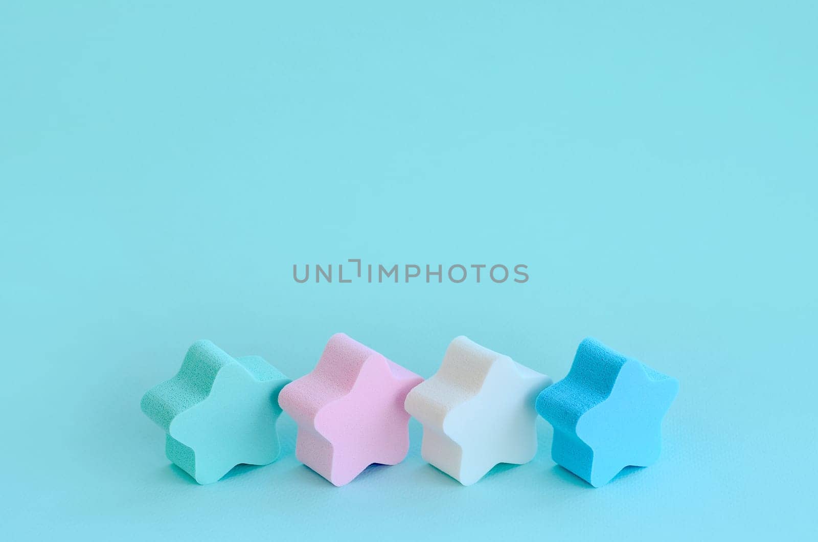 Abstract cosmetic light pastel blue background with small stars of sponges. Template with text space
