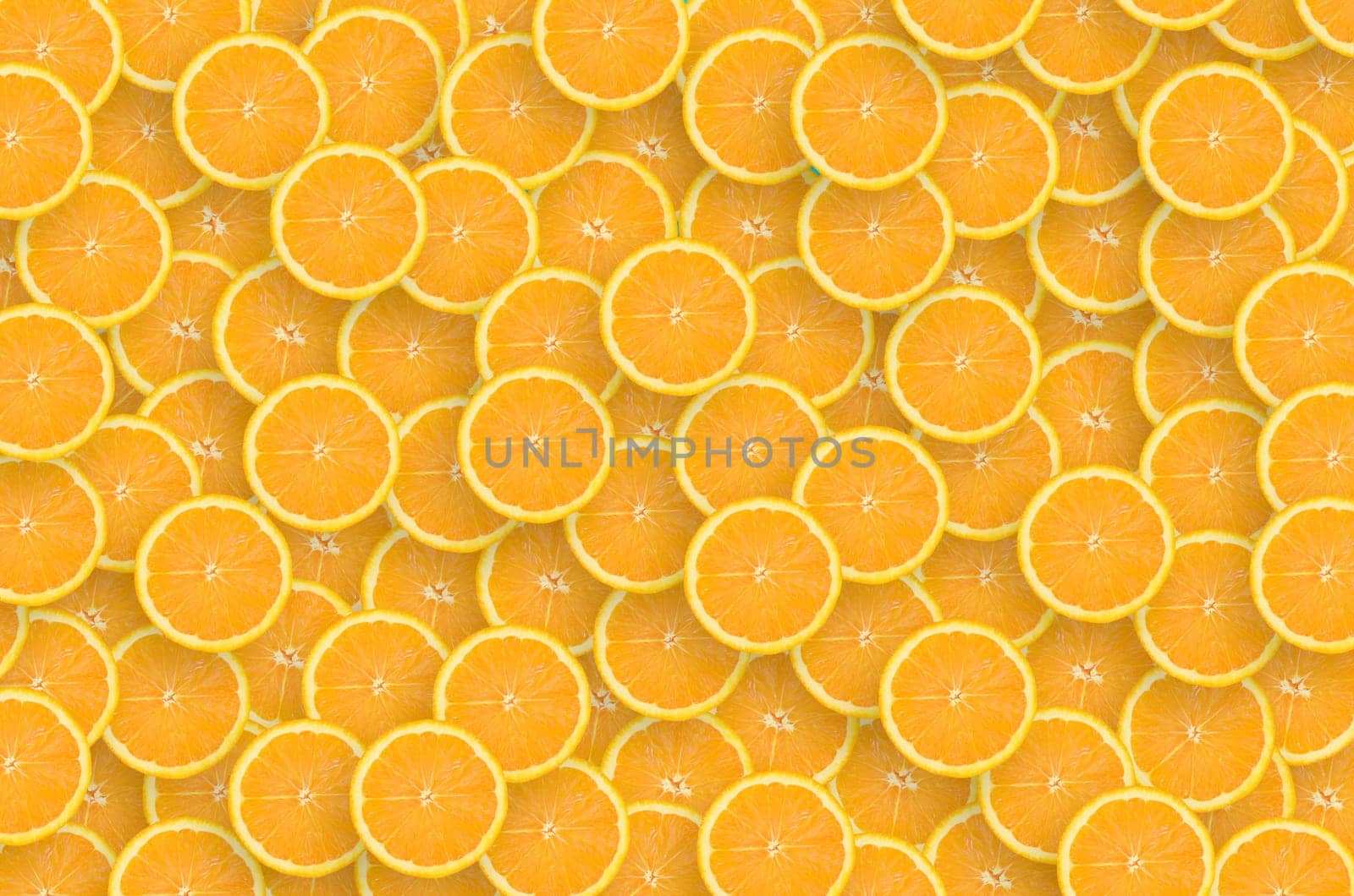 Top view of many orange fruit slices as a background image. A saturated citrus pattern. Flat lay