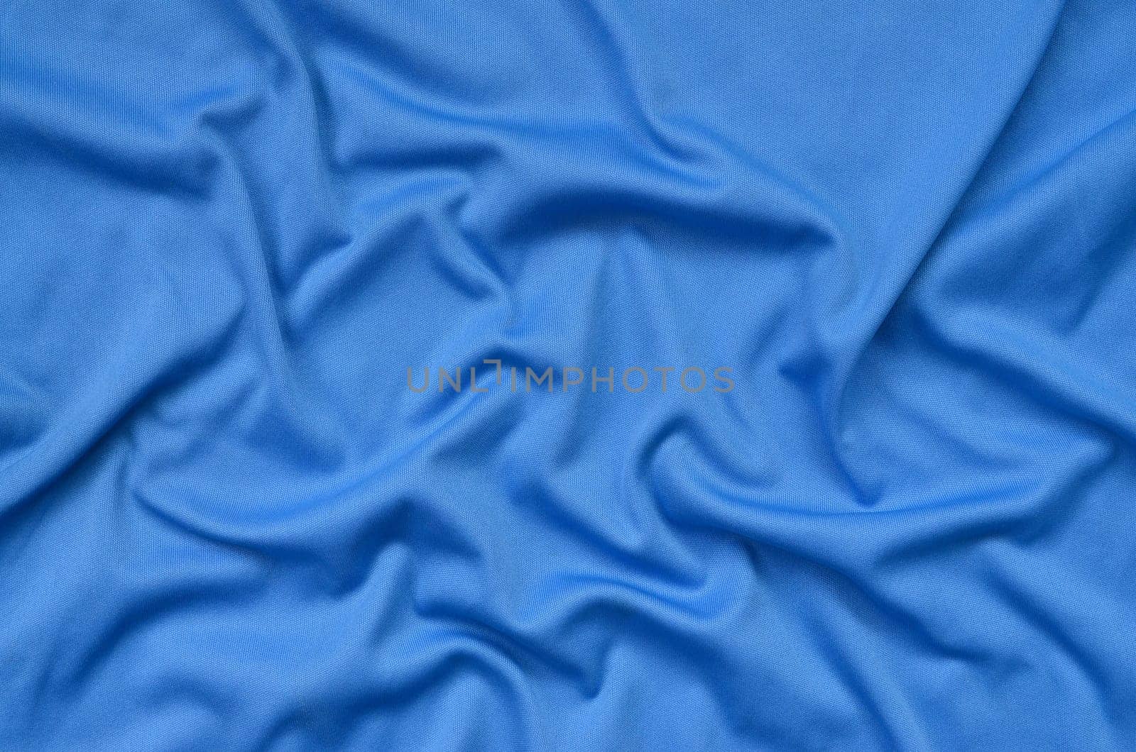 Detailed polyester blue fabric texture with many long folds