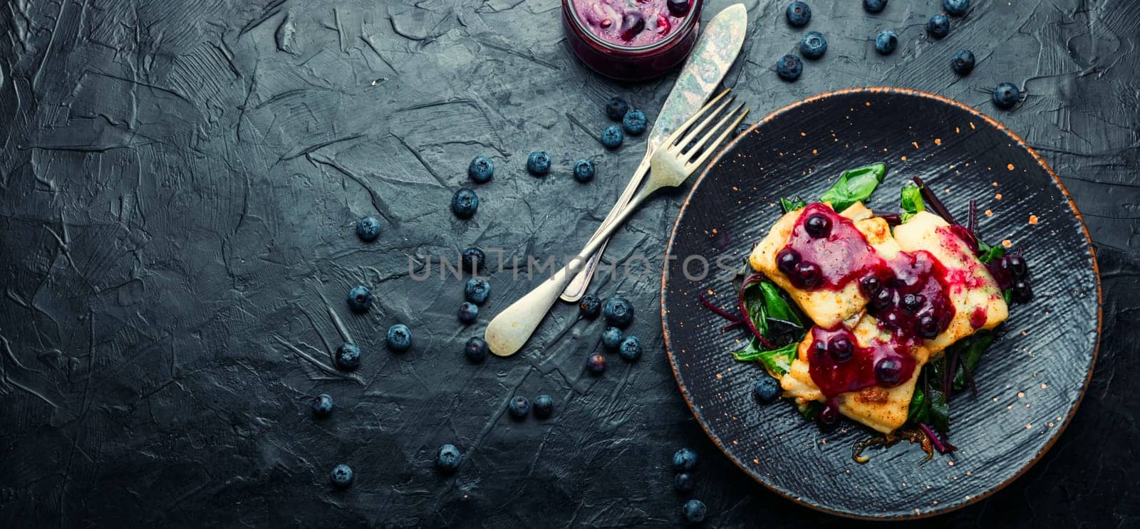 Delicious baked fish with berry sauce. Stewed pangasius with blueberries