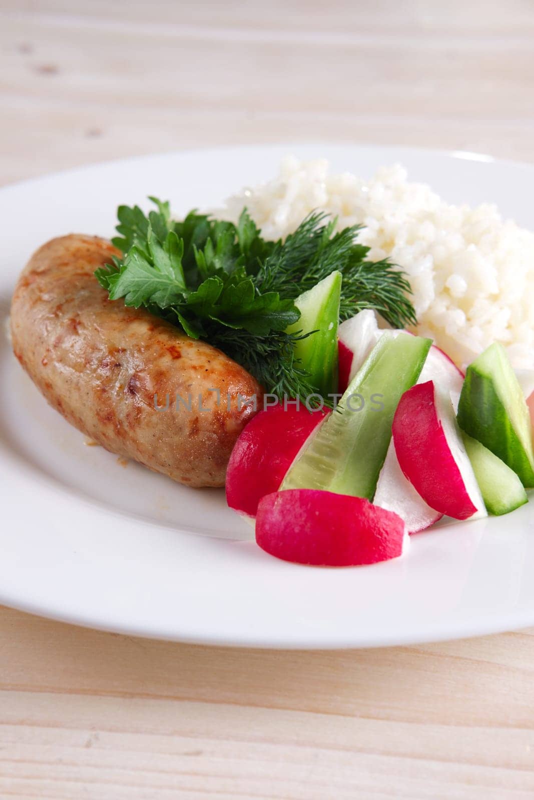 Fried sausage with rice and fresh cucumber and radish