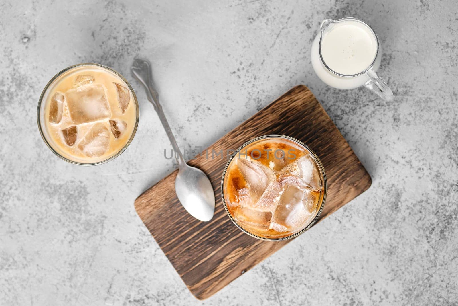 Top view of iced coffee with fat cream in rocks glass