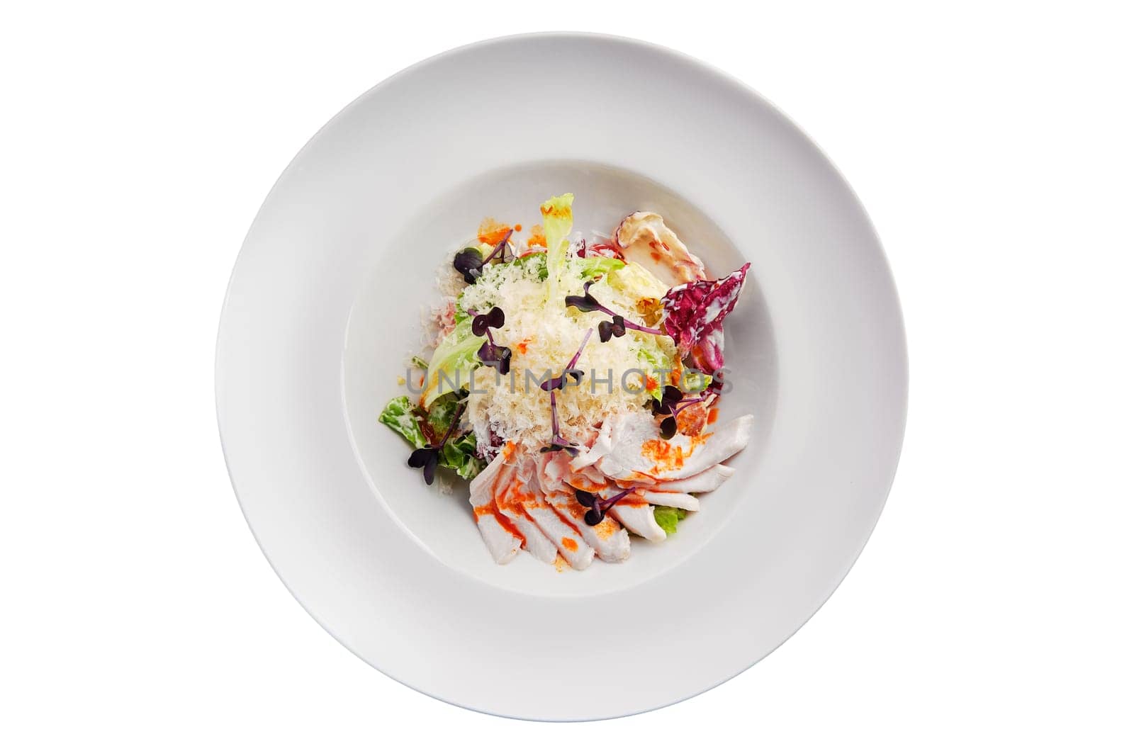 Salad with green and red cabbage and ham isolated on white background