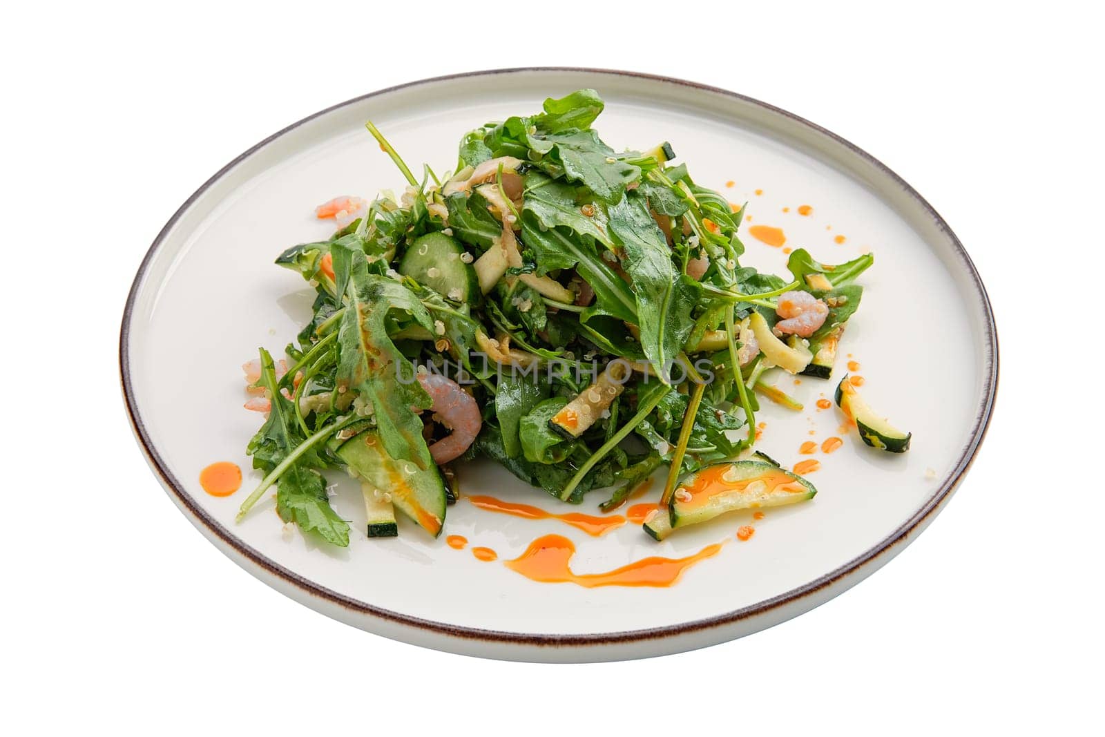 Salad with shrimps, arugula, cucumber and spicy sauce isolated on white background