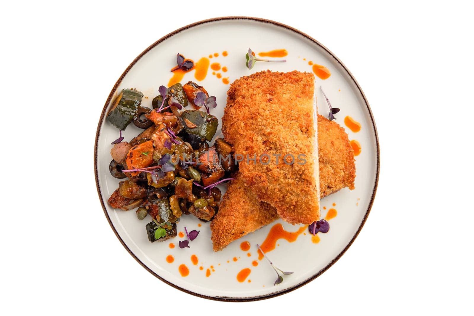 Cutlet with stuffing in breading with fried eggplant, olives and onion isolated on white background