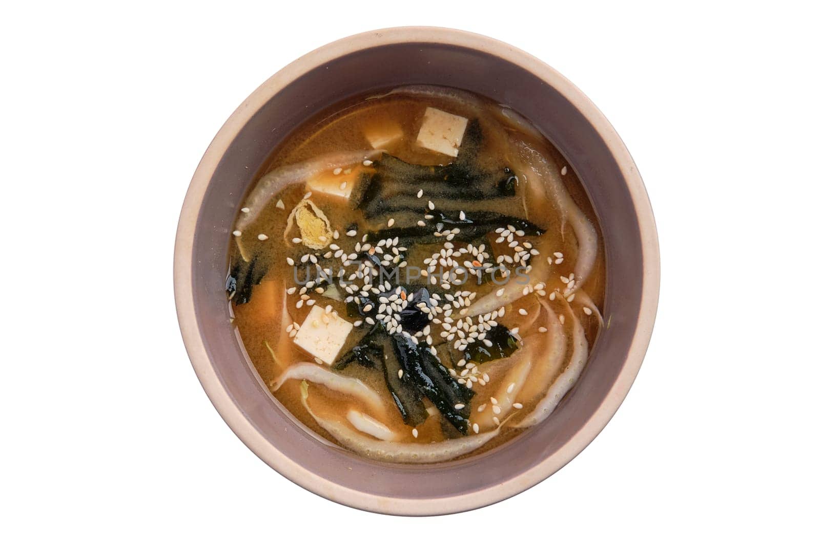 Soup with noodles, sea wed and tofu isolated on white background