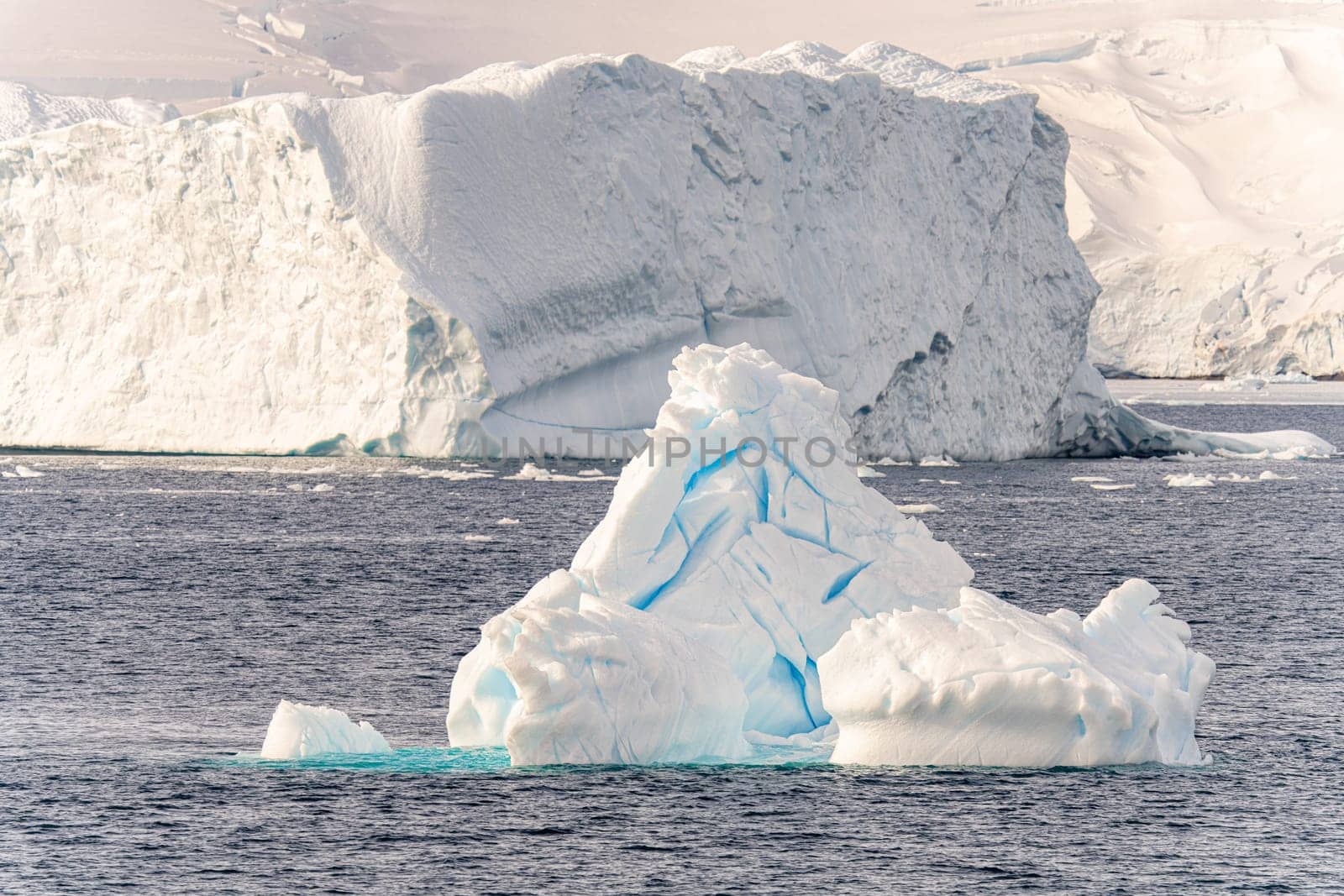 Antarctic iceberg landscape in Cierva Cove - a deep inlet on the west side of the Antarctic Peninsula, surrounded by rugged mountains and dramatic glacier fronts.