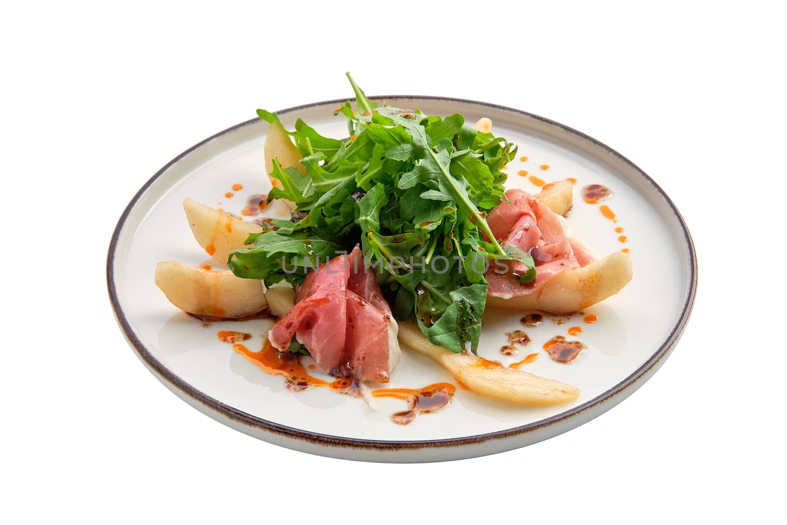 Salad with jamon, pear and arugula isolated on white background