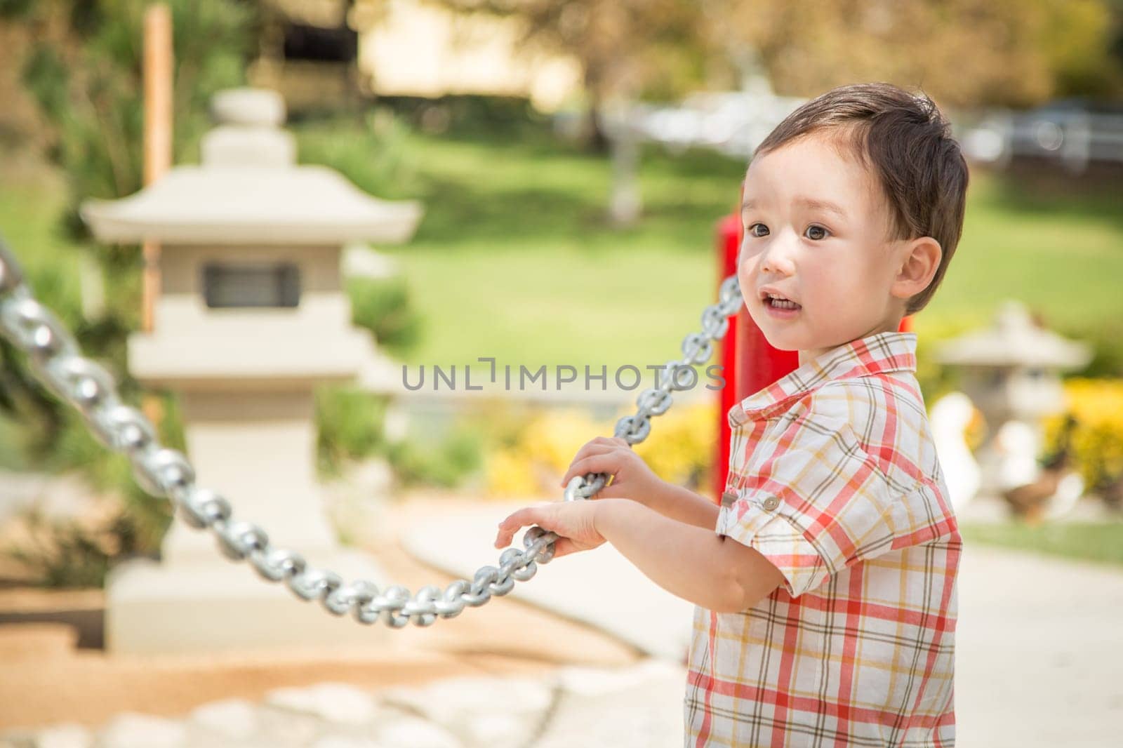 Young Chinese and Caucasian Boy Having Fun at the Park.