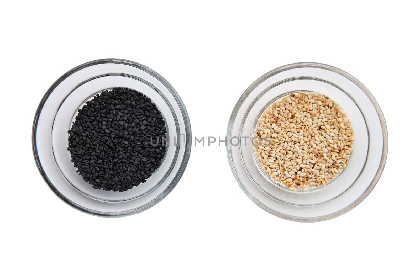 Top view of sesame seeds in a little bowls isolated on white background
