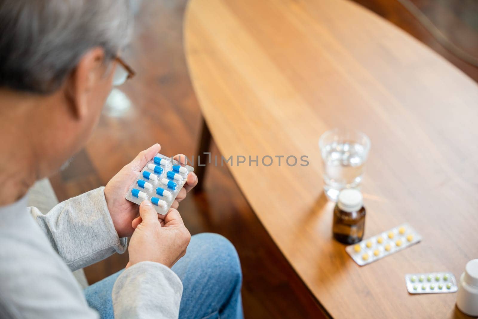 Asian old man buy herbal self cure Rx pill online from pharmacy, worried senior man with medicine pills he read on see how to take pills before taking, home isolation, Medical service concept