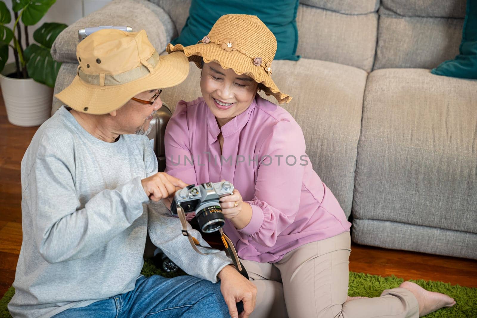 Travel and tourism. Happy mature retired couple photography weekend holiday, Asian couple old senior marry retired couple smiling taking photo by camera during luggage suitcase arranging for travel