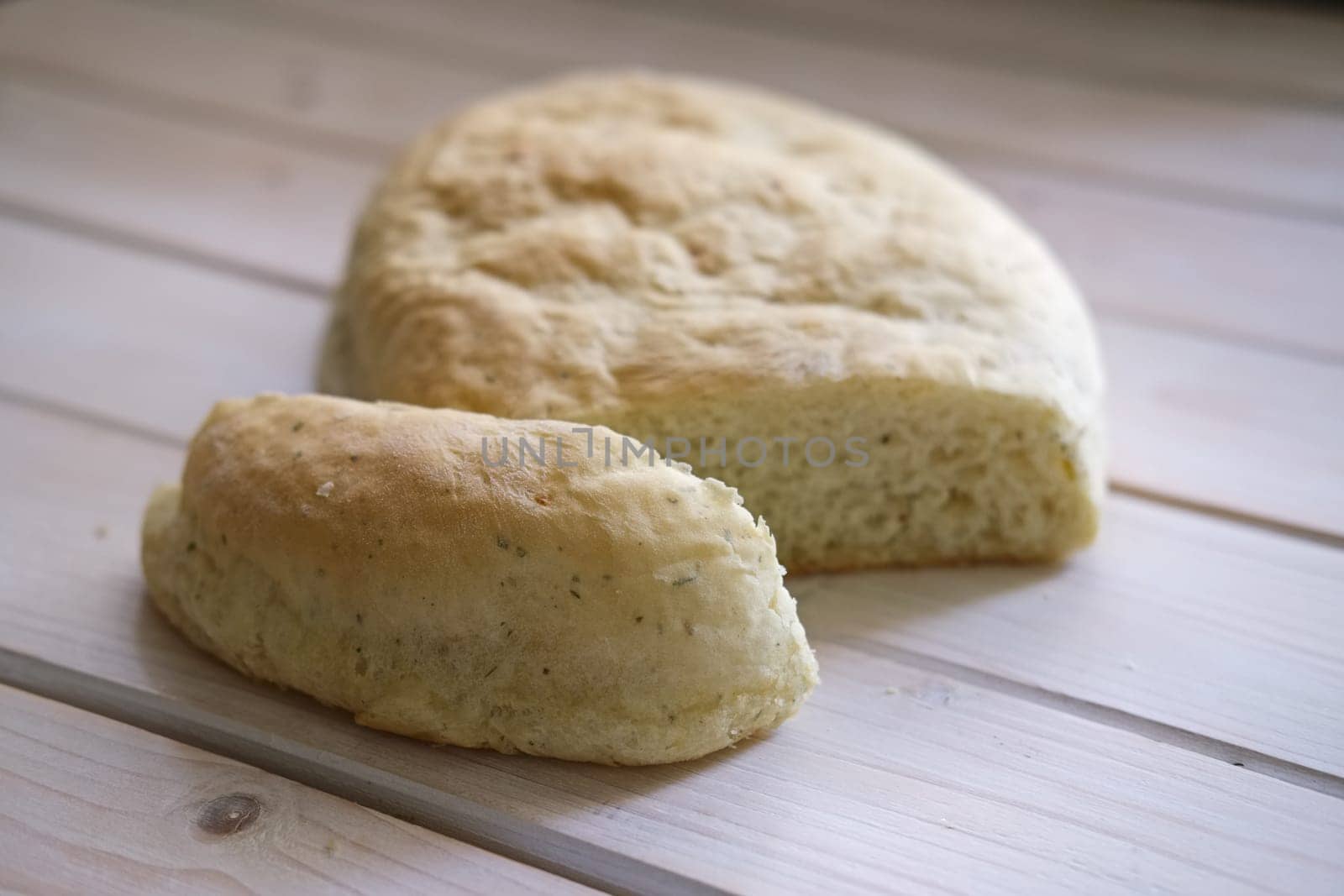 Freshly baked homemade white bun with herbs