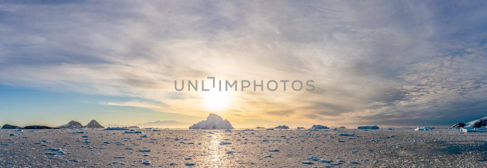 dramatic, colourful sunset / evening atmosphere in Cierva Cove - a deep inlet on the west side of the Antarctic Peninsula, surrounded by Cierva Bay in San Martín Land - Antarctica photographed from an expedition ship
