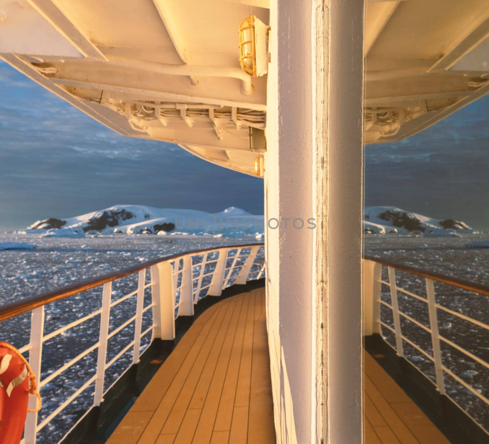 Cabin window reflection on a cruise ship at a dramatic sunset in wintry Cierva Cove - a deep inlet on the west side of the Antarctic Peninsula, surrounded by Cierva Bay in San Martín Land – Antarctica
