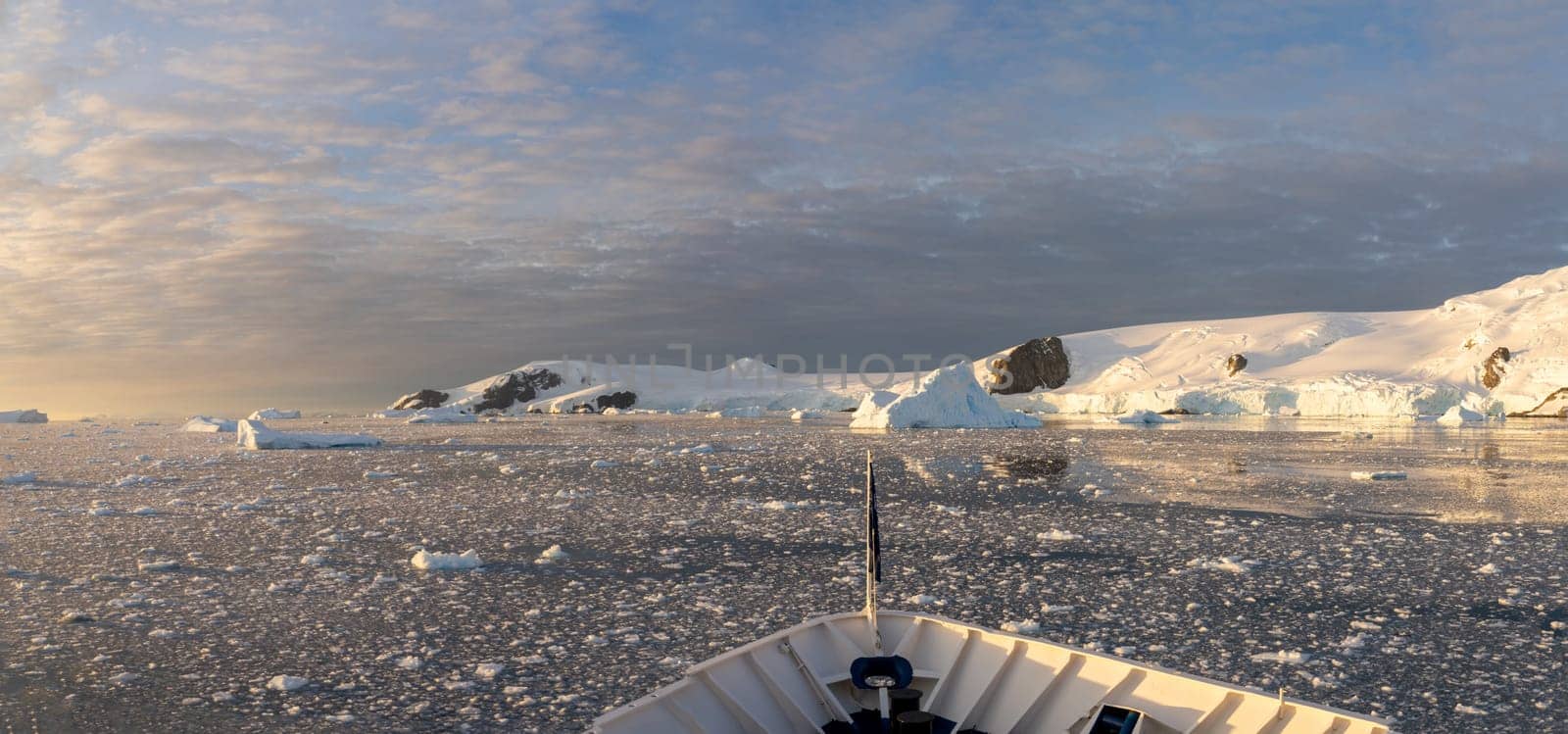 dramatic, colourful sunset / evening atmosphere in Cierva Cove - a deep inlet on the west side of the Antarctic Peninsula, surrounded by Cierva Bay in San Martín Land - Antarctica photographed from an expedition ship
