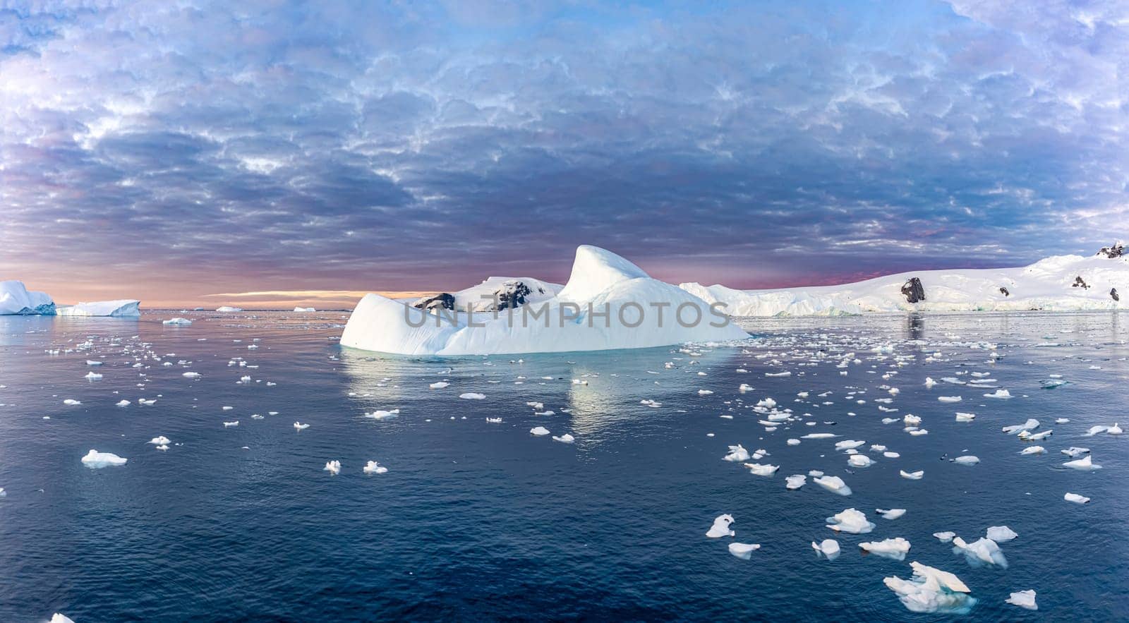 dramatic, colourful sunset / evening atmosphere in Cierva Cove - a deep inlet on the west side of the Antarctic Peninsula, surrounded by Cierva Bay in San Martín Land - Antarctica photographed from an expedition ship