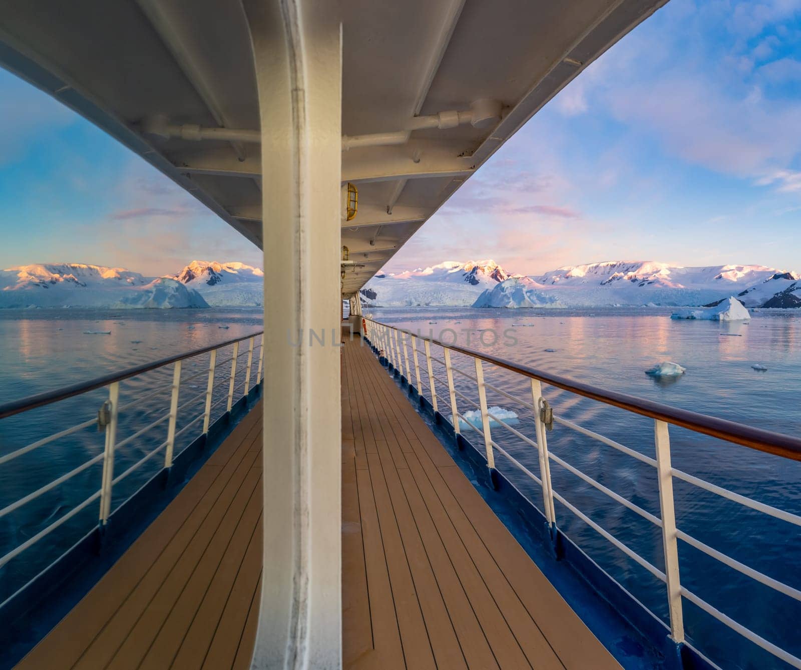 Cabin window reflection on a cruise ship at a dramatic sunset in wintry Cierva Cove - a deep inlet on the west side of the Antarctic Peninsula, surrounded by Cierva Bay in San Martín Land – Antarctica