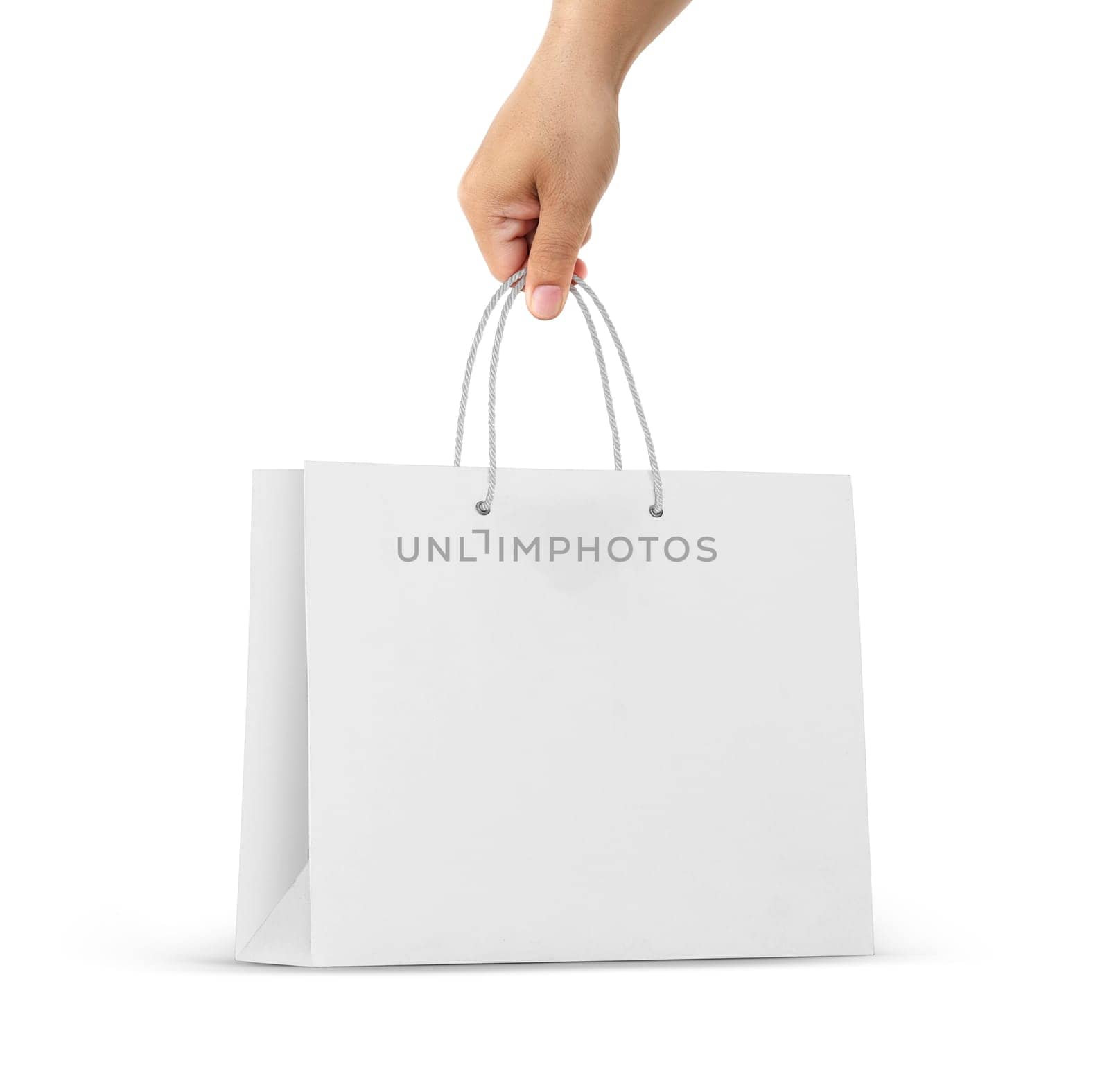 Hand holds a paper bag on a white background
