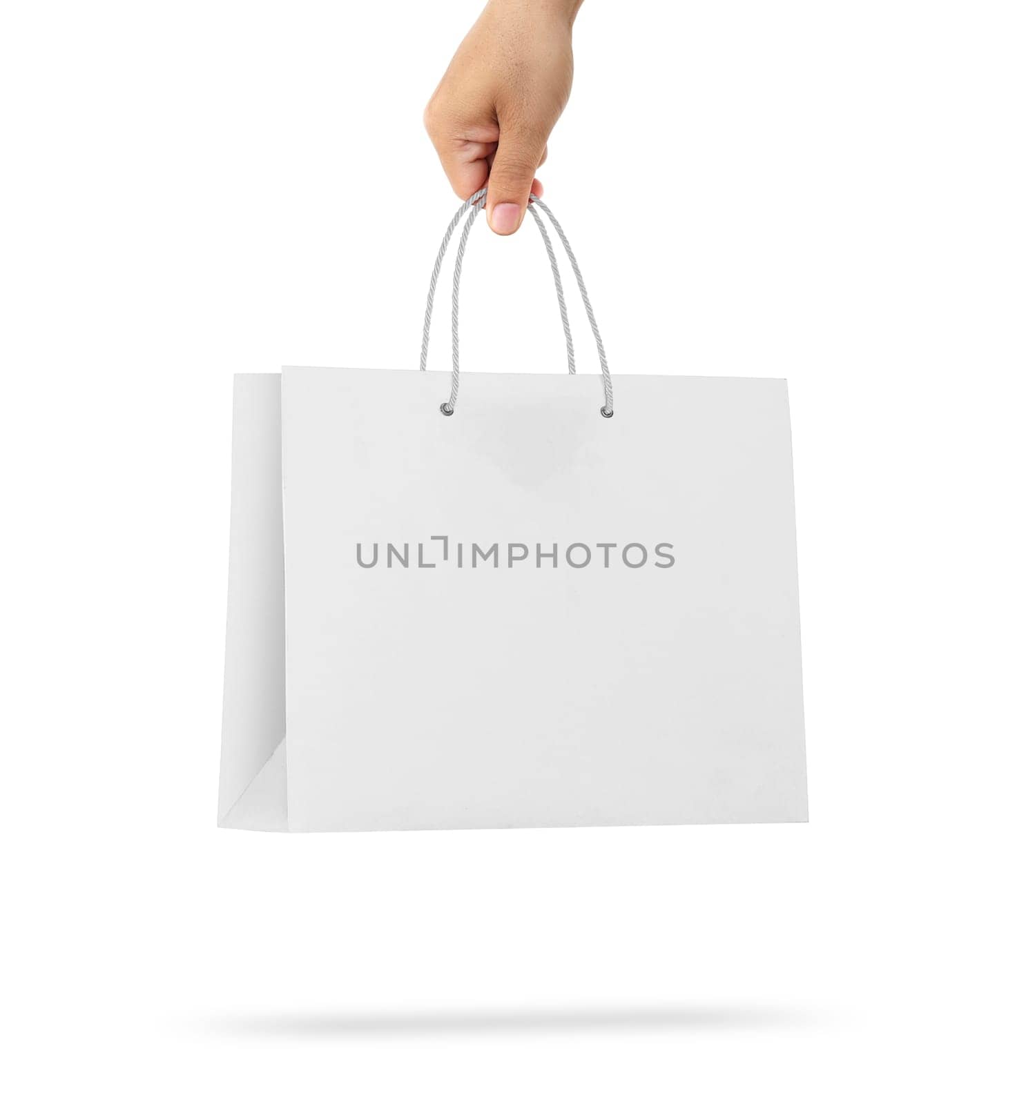 Hand holds a paper bag on a white background