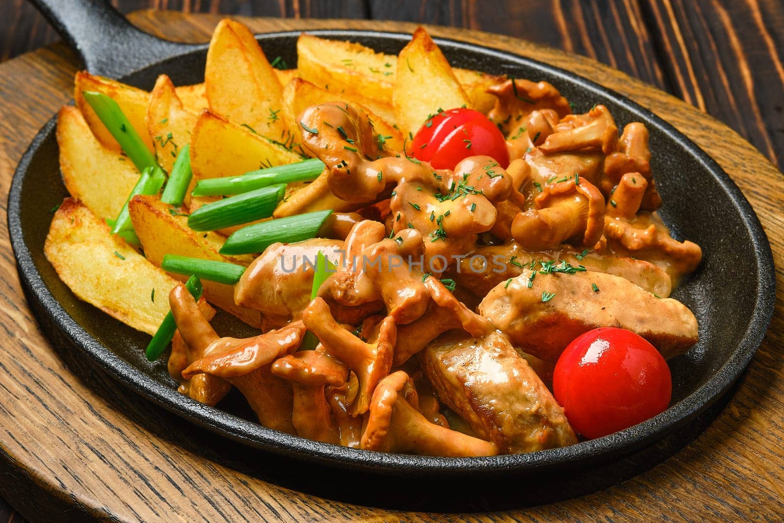 Potato pancakes with chanterelles and pork in cast iron skillet