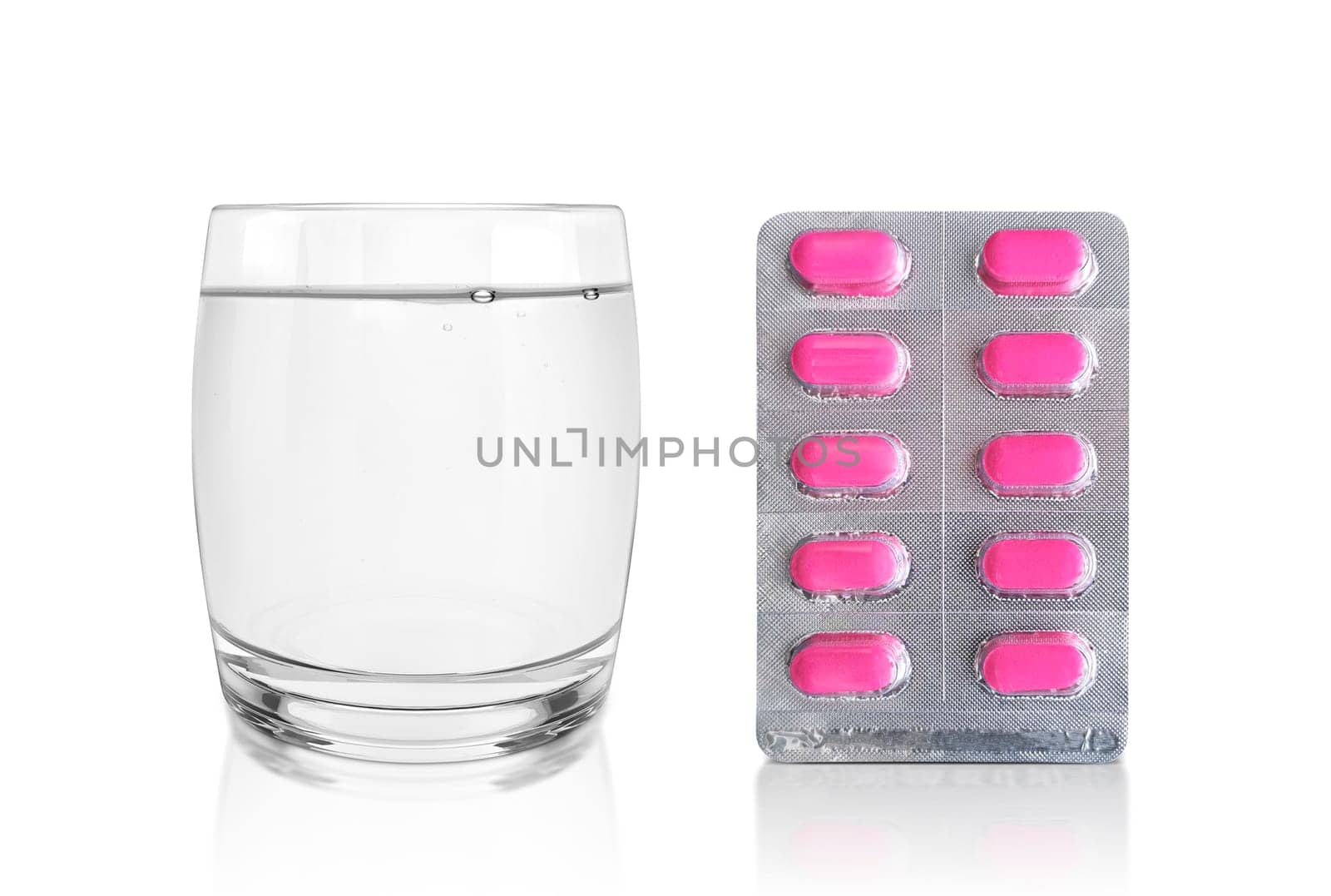 Package of pills and a Glass of Water. Pharmacy and medicine concept