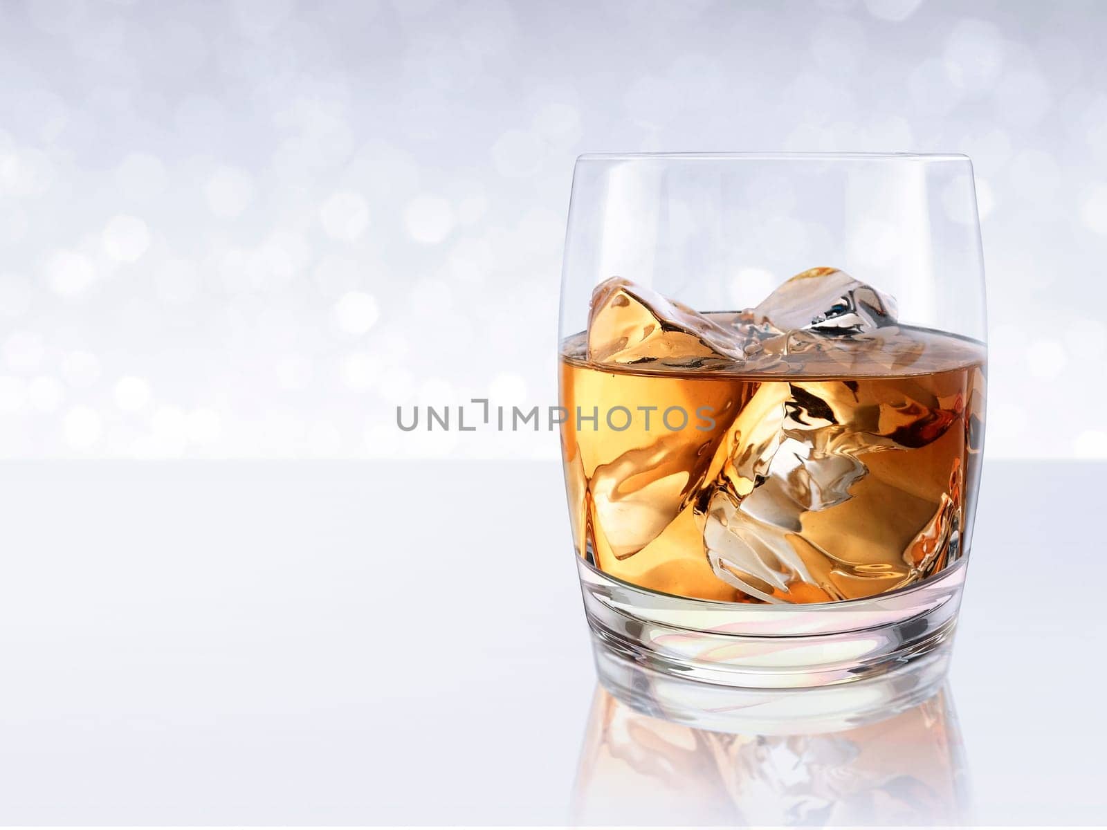 Whiskey with ice in a glass on white shining bokeh background. 3d render