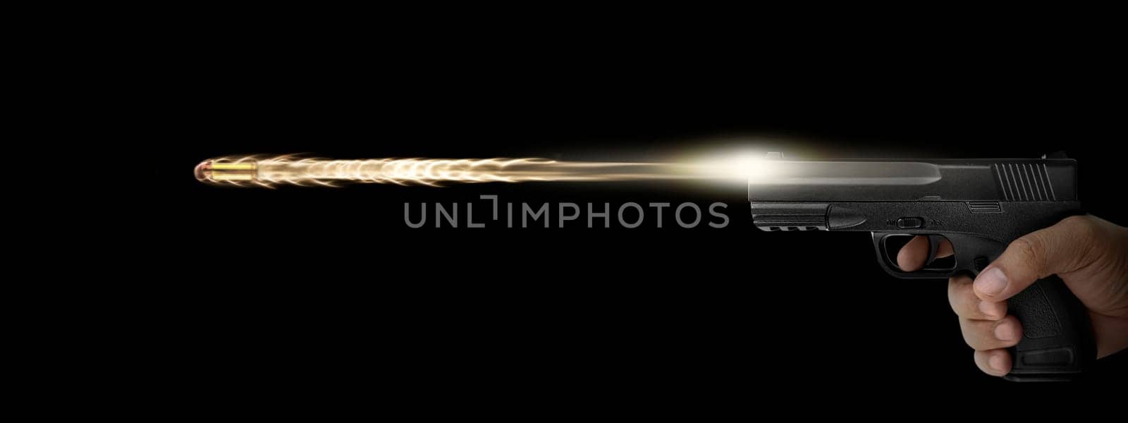 The hand presses the trigger of the gun and the flame from the shot escapes from its muzzle