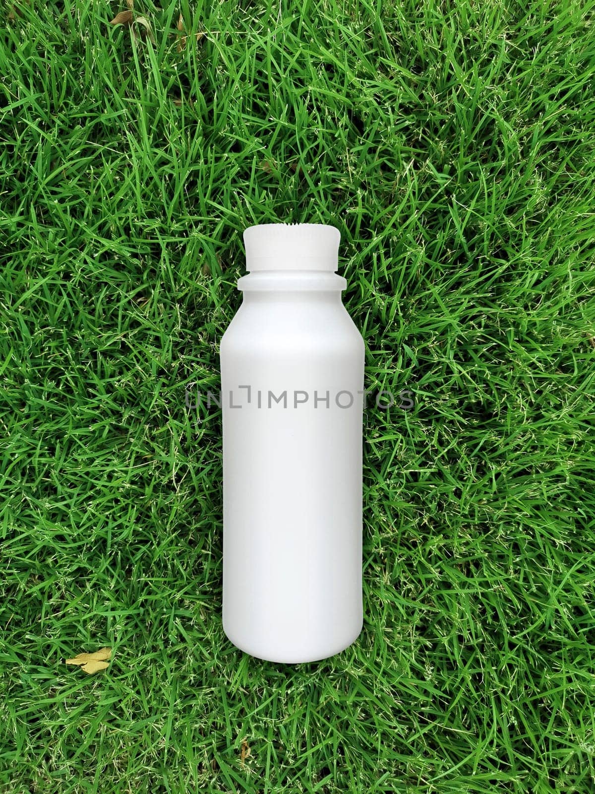 top view of milk bottle on the grass